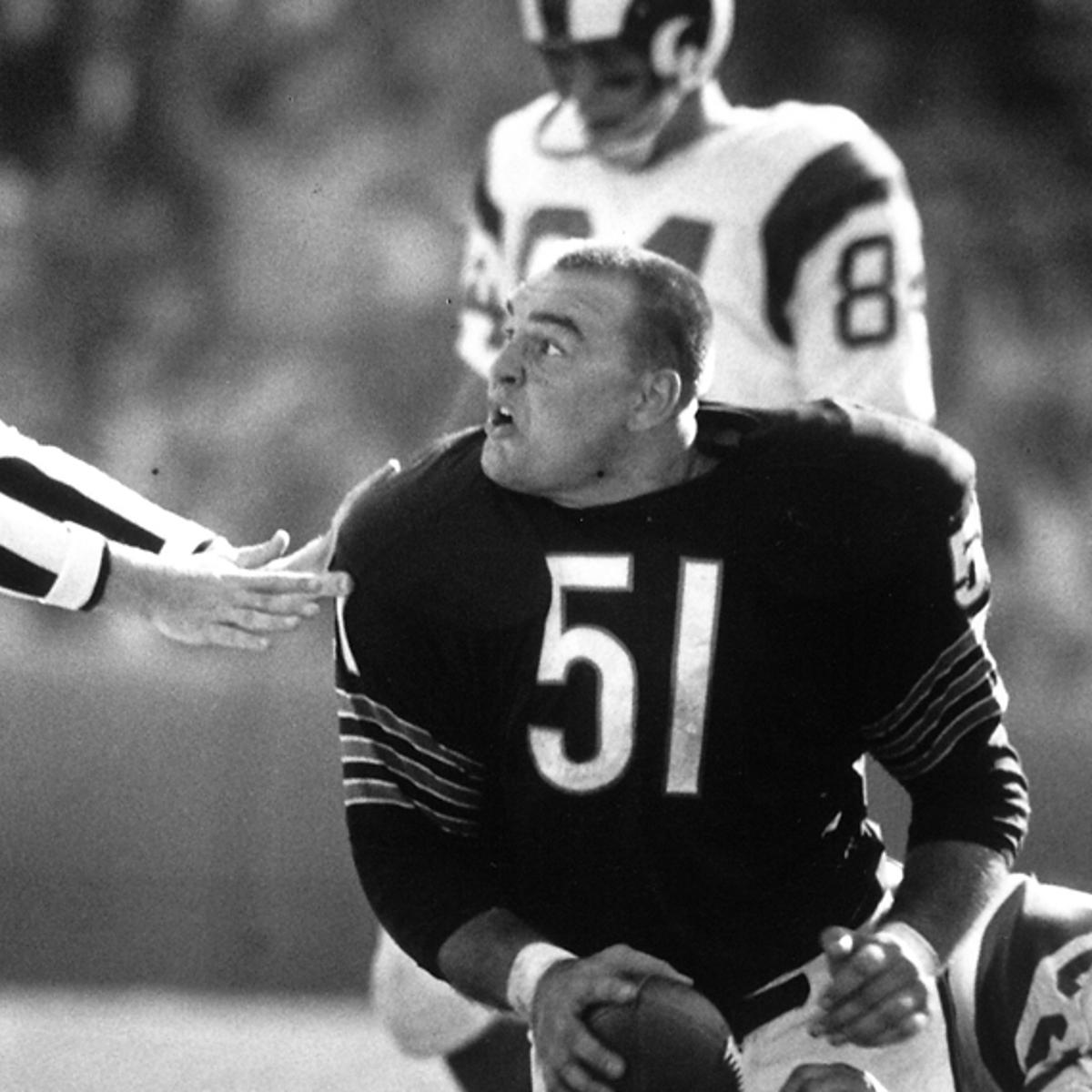 Dick Butkus appears agitated after recovering a fumble against the Rams during his rookie season with the Bears in 1965.