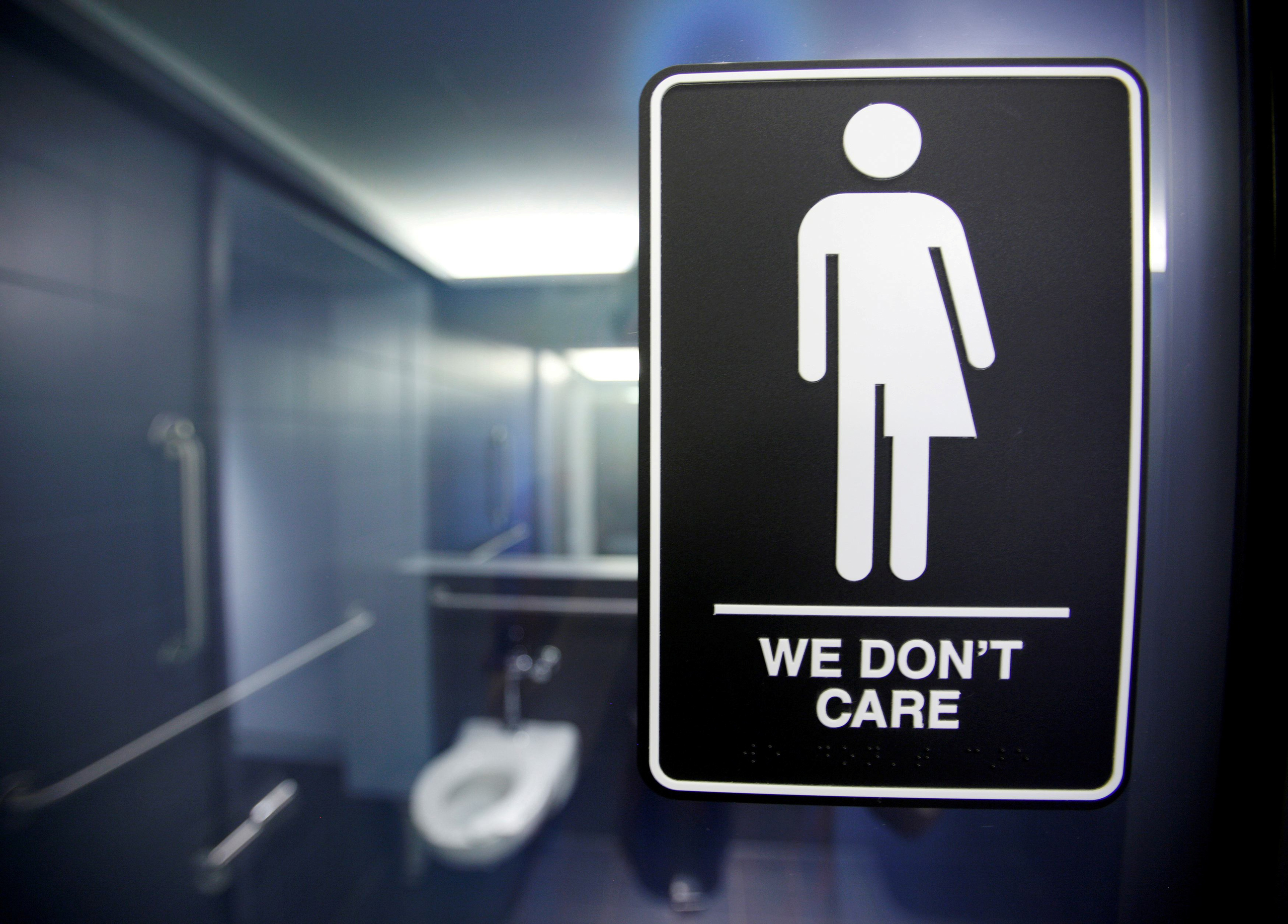 A sign protesting a recent North Carolina law restricting transgender bathroom access is seen in the bathroom stalls at the 21C Museum Hotel in Durham, North Carolina May 3, 2016. REUTERS/Jonathan Drake/File photo TPX IMAGES OF THE DAY - RTSE95S