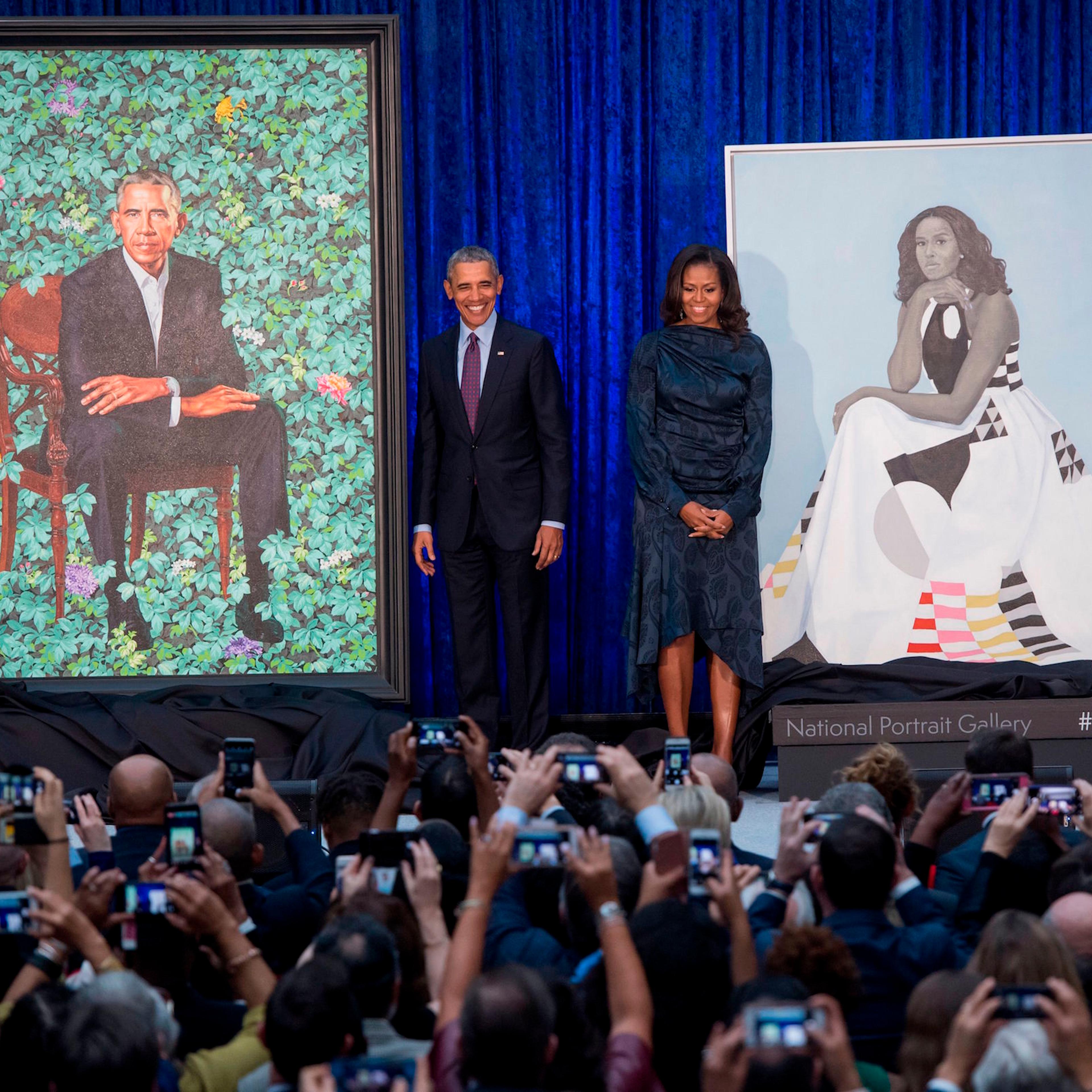 Barack and Michelle Obama with portraits by Kehinde Wiley and Amy Sherald
