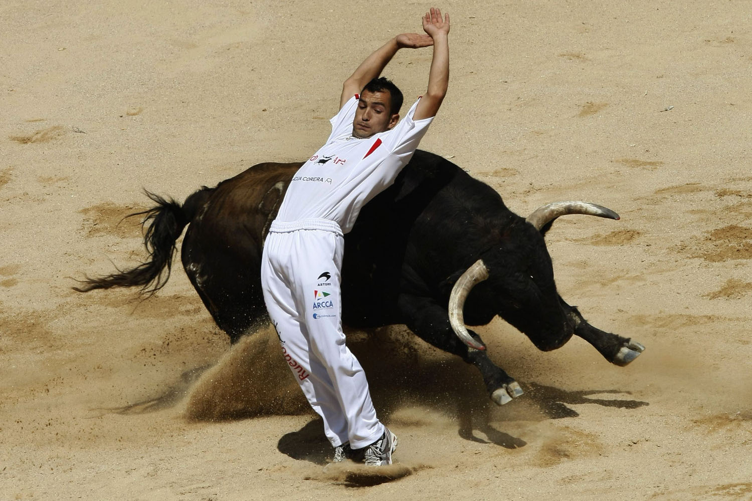 July 8, 2012. A recortador performs a pass during a contest at Pamplona's bull ring on the third day of the San Fermin festival.