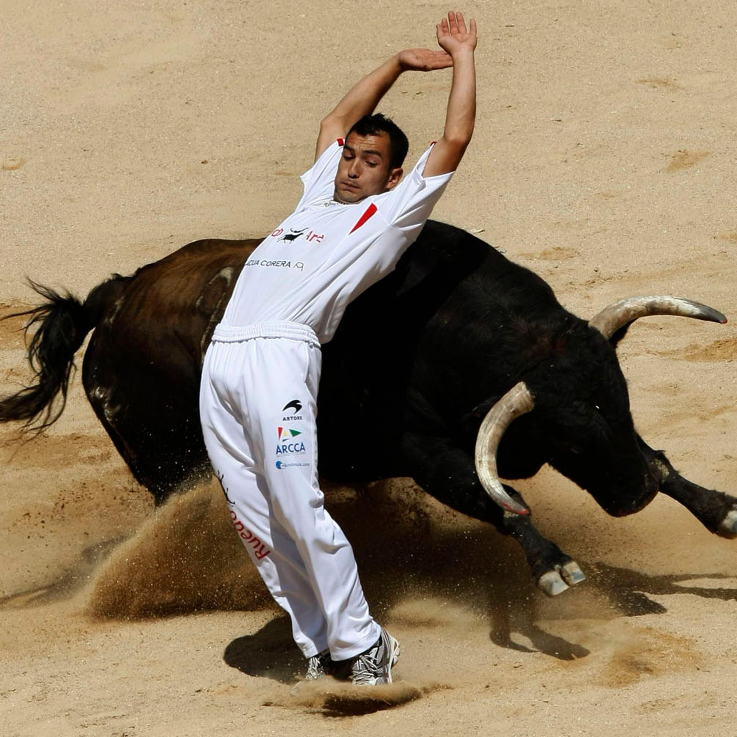 July 8, 2012. A recortador performs a pass during a contest at Pamplona's bull ring on the third day of the San Fermin festival.