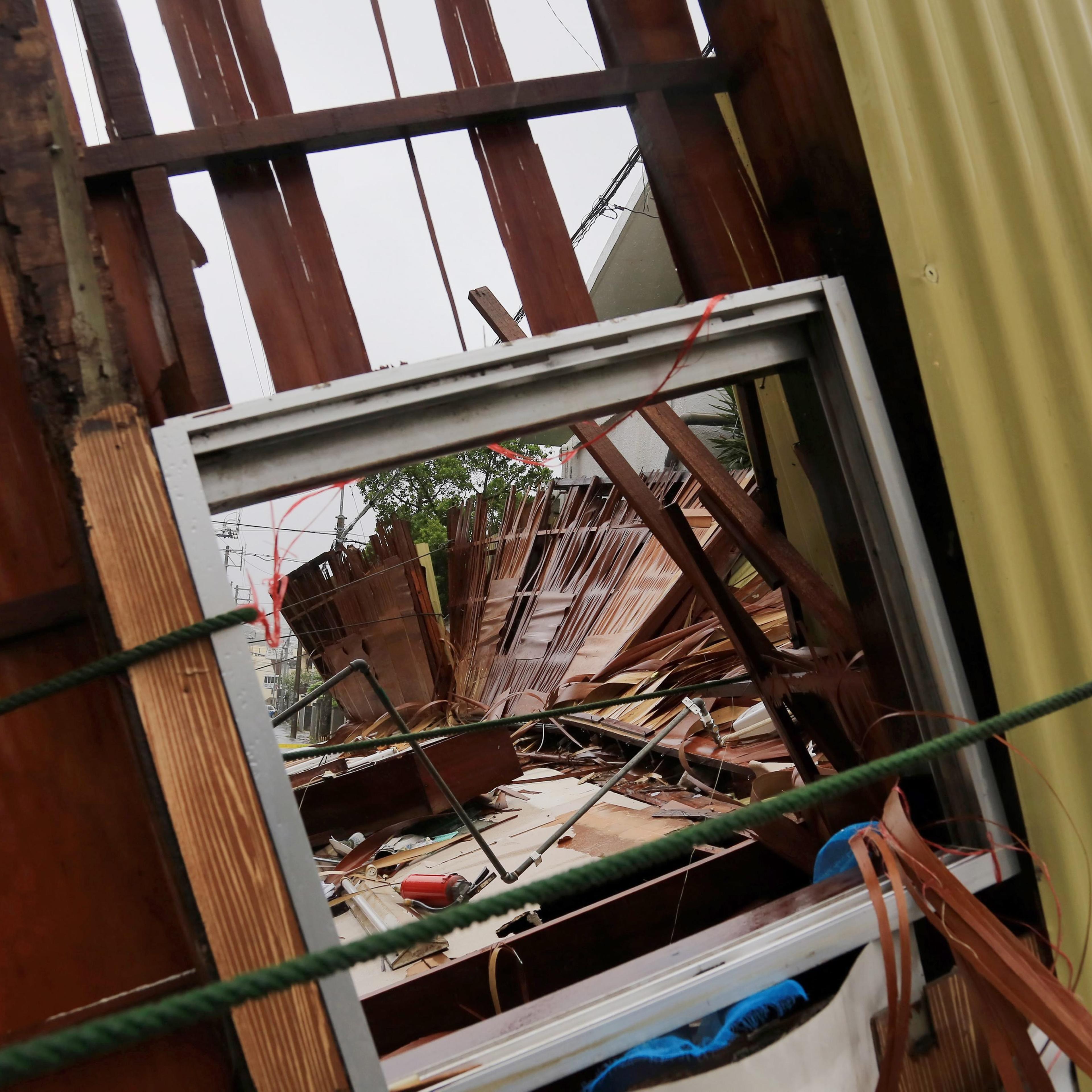 A wooden house hosting a restaurant lies on a street after it collapsed due to the strong generated by typhoon Neoguri in Matsugawa district of Naha city, on the island of Okinawa, southern Japan on July 8, 2014.