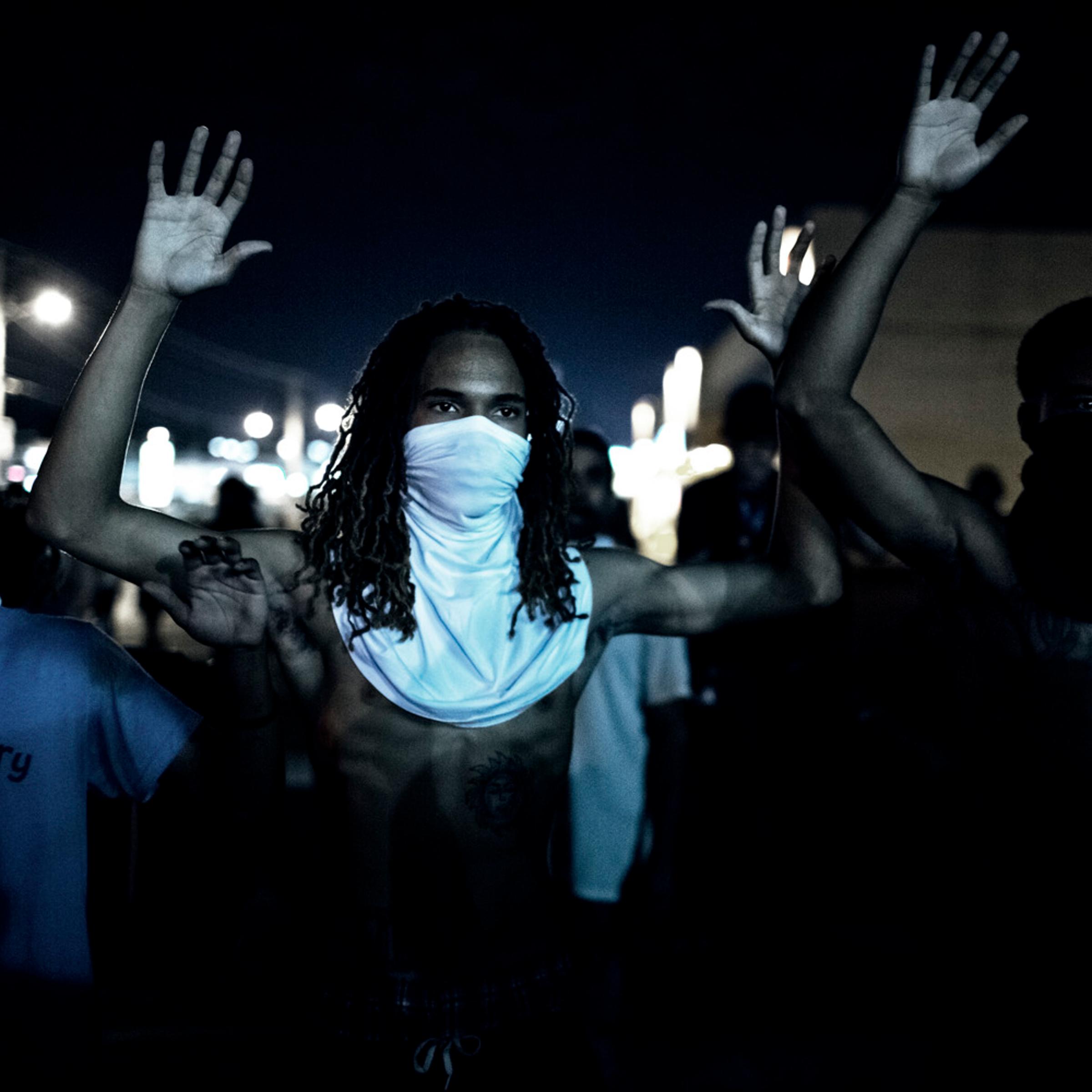Demonstraters during clashes with police that erupted folwoing a mostly peacful protest at 12:30 AM on Wednesday, Aug 20, 2014 in Furguson, MO.