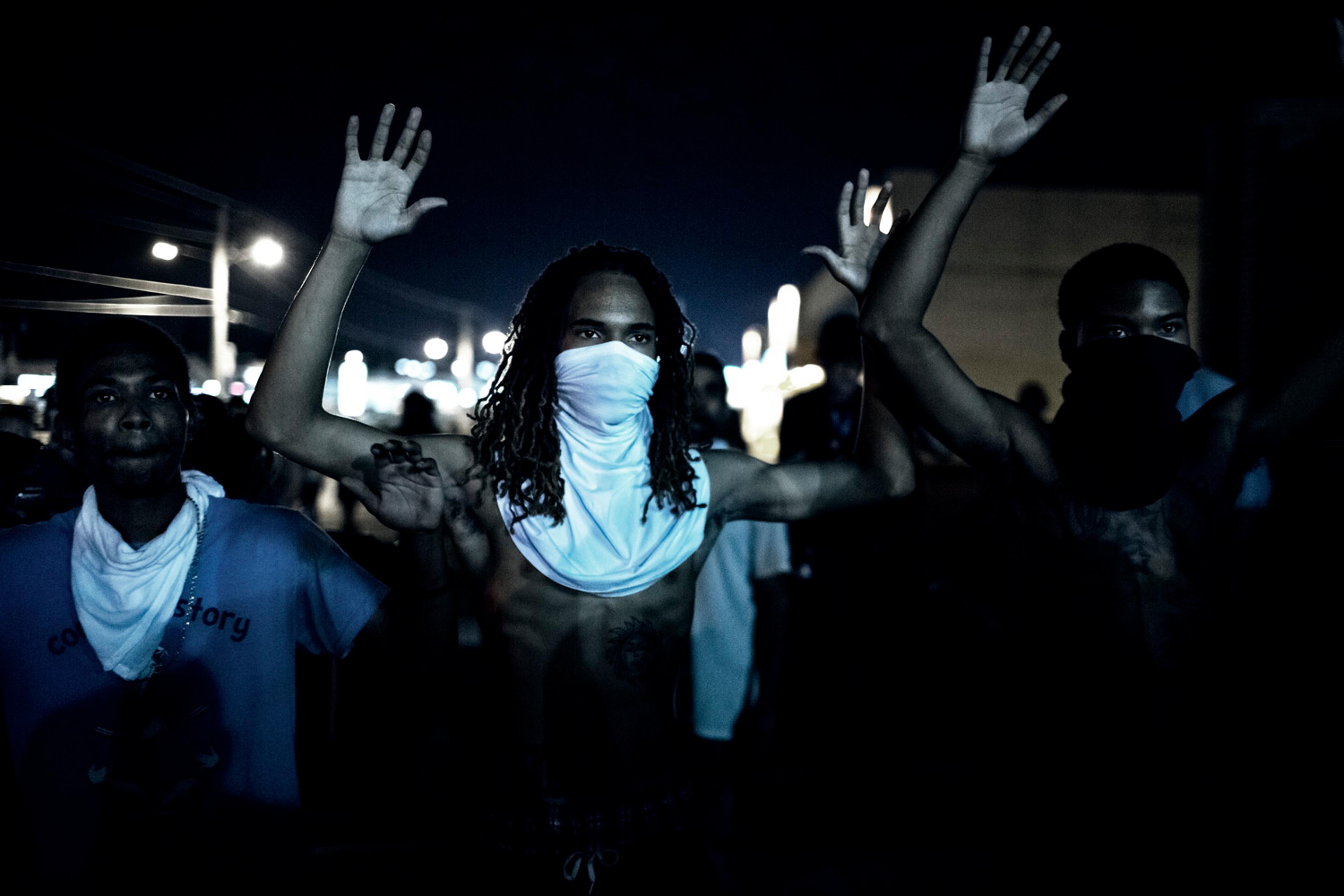 Demonstraters during clashes with police that erupted folwoing a mostly peacful protest at 12:30 AM on Wednesday, Aug 20, 2014 in Furguson, MO.