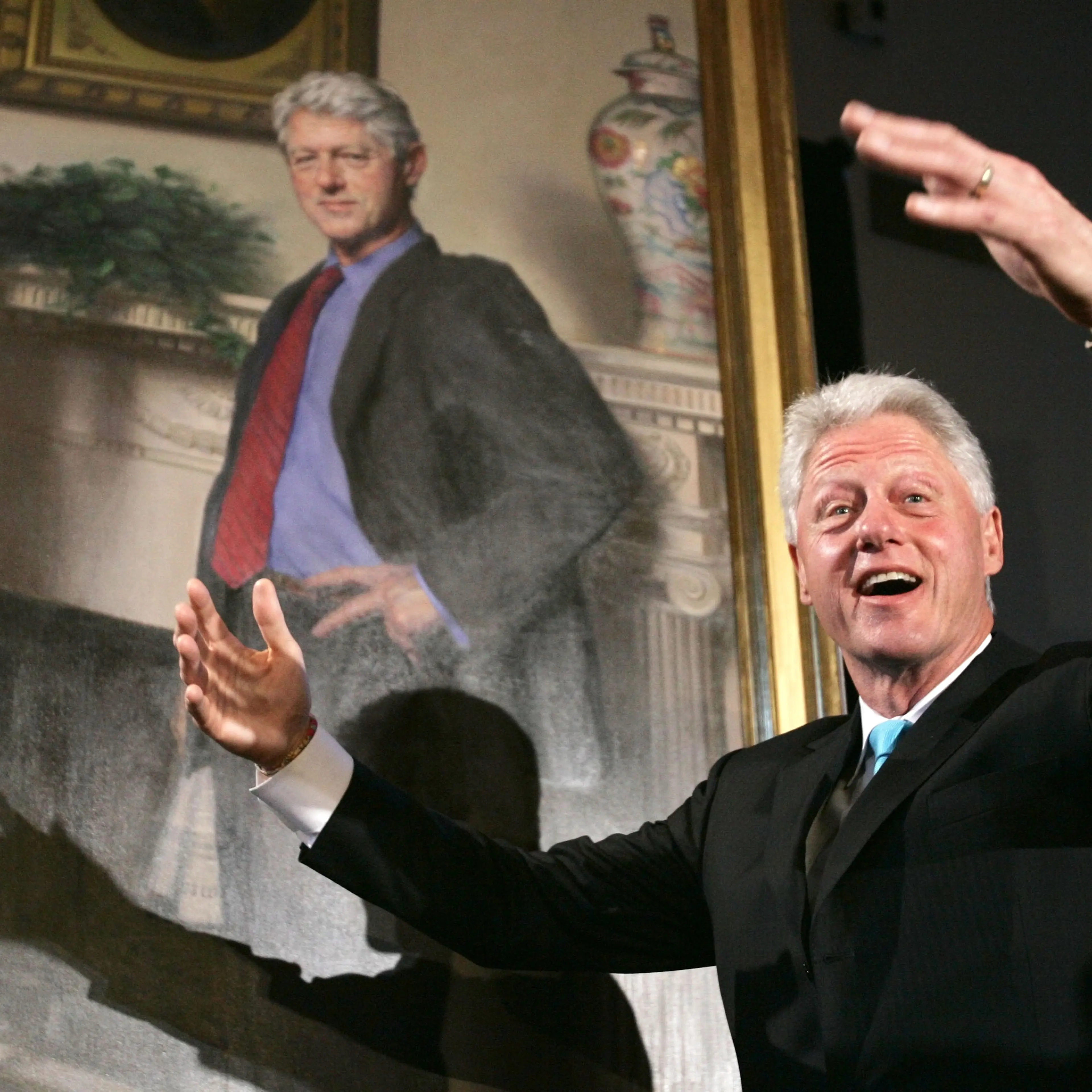 Former President Bill Clinton gestures after the portraits of his wife, Hillary Rodham Clinton and him, were revealed on April 24, 2006 at the Smithsonian Castle Building in Washington D.C.