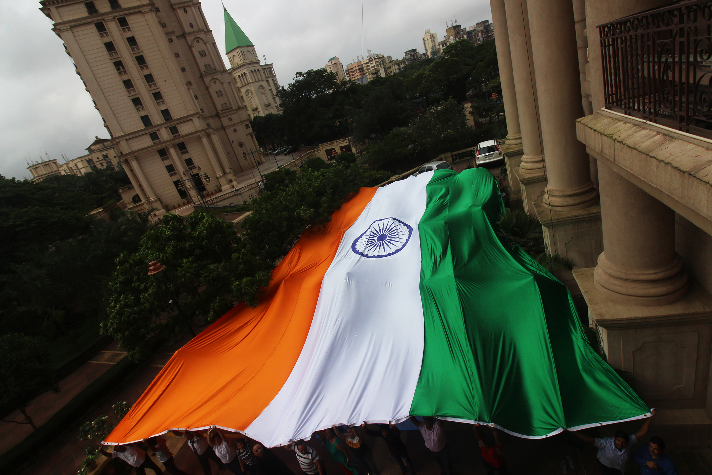 People hold a giant Indian national flag ahead of the 73rd Independence Day celebrations in Mumbai in August 2019.