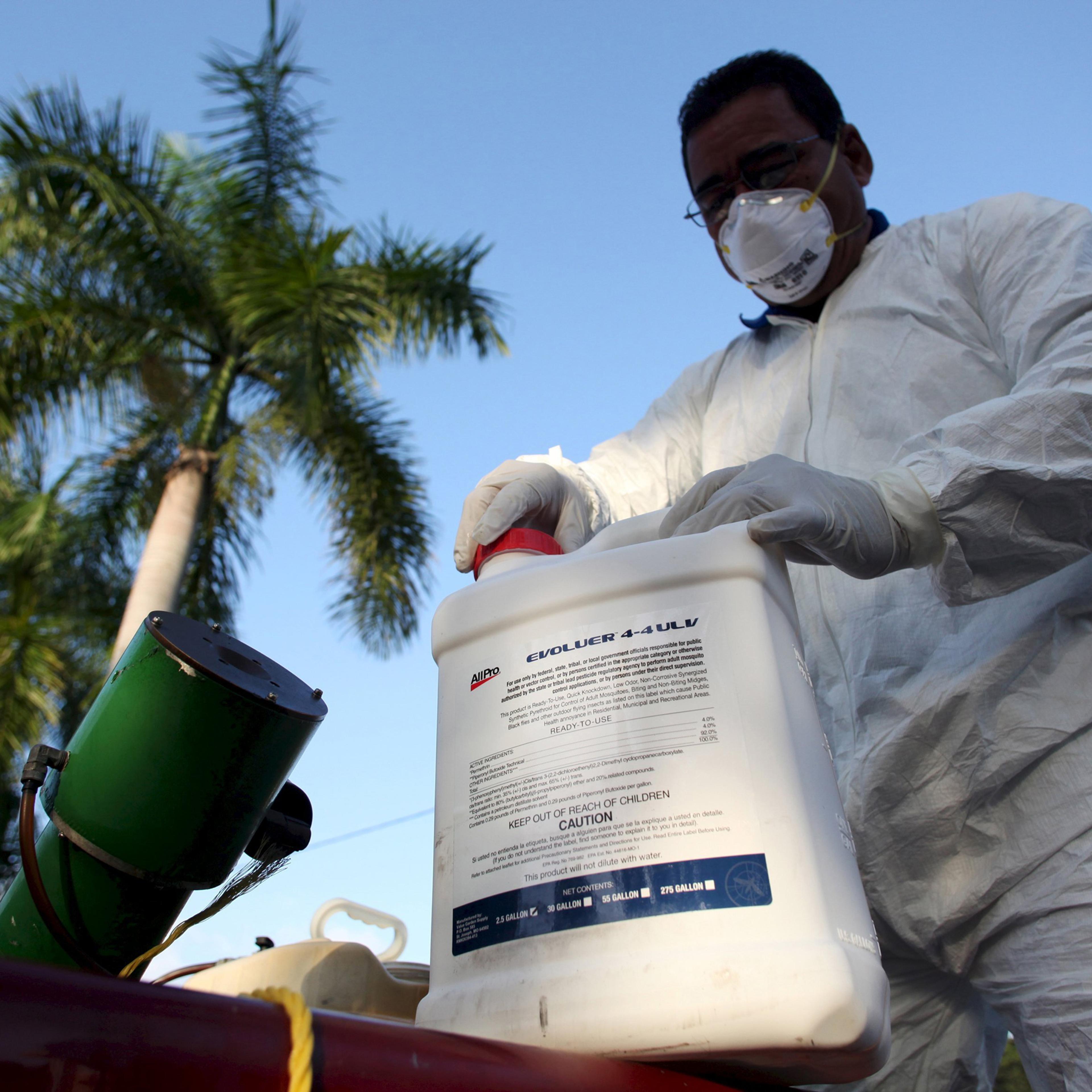 File photo of a health worker preparing insecticide before fumigating a neighborhood in San Juan