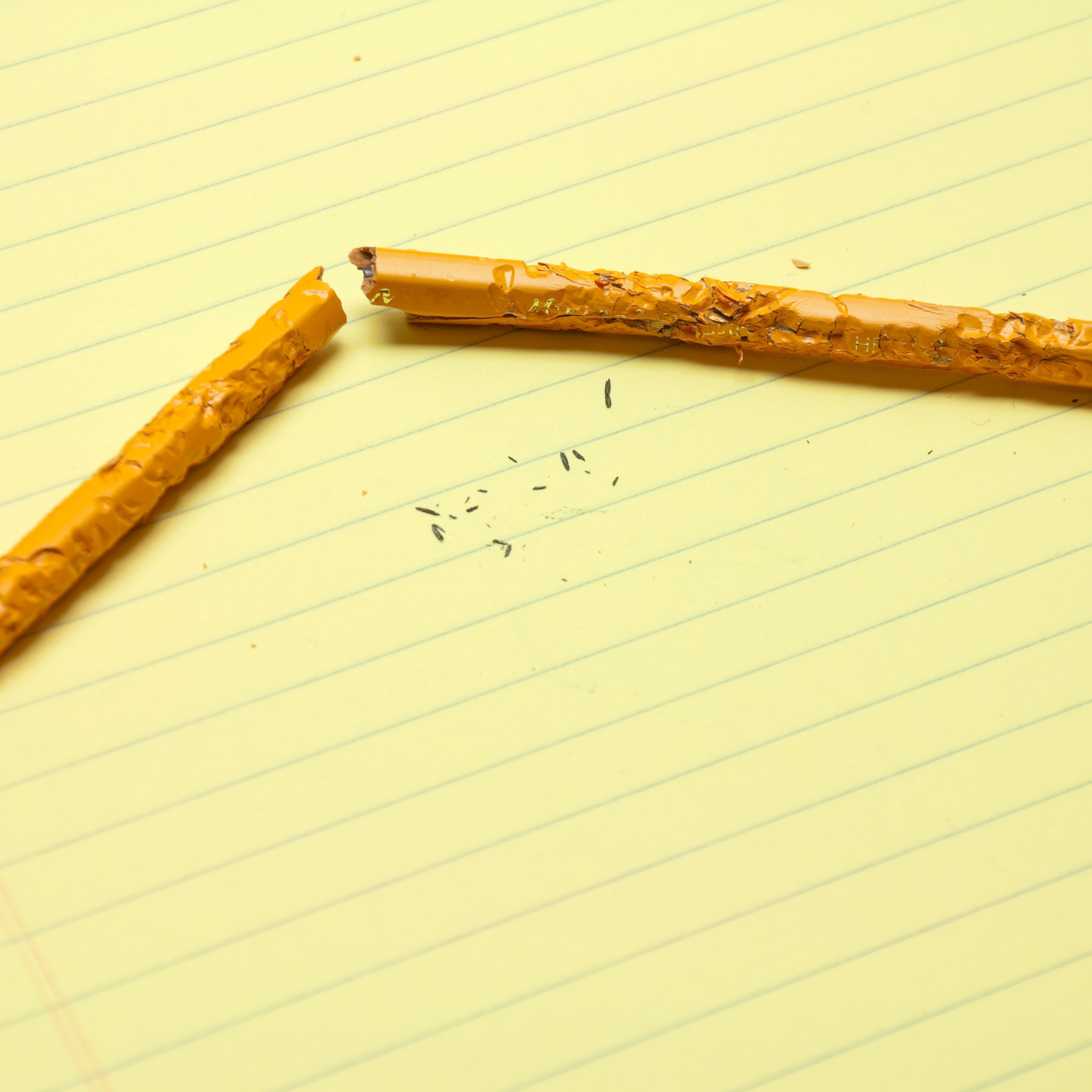 Broken Chewed Pencil On Notepad