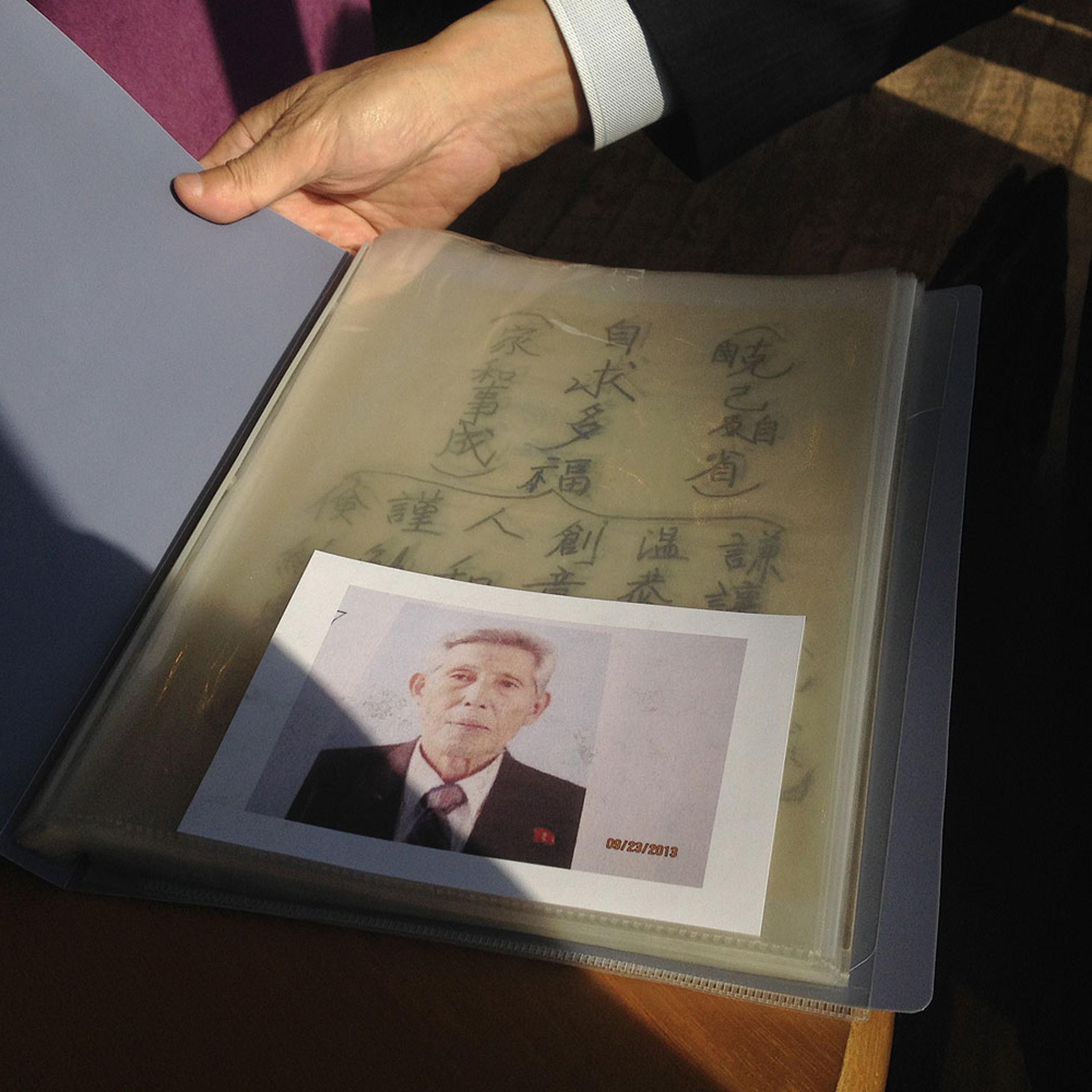 South Korean Kwon Dong-yul, 73, shows a picture of his brother, Kwon Eung-ryul, 88, who lives in North Korea. On Sunday, they were briefly reunited