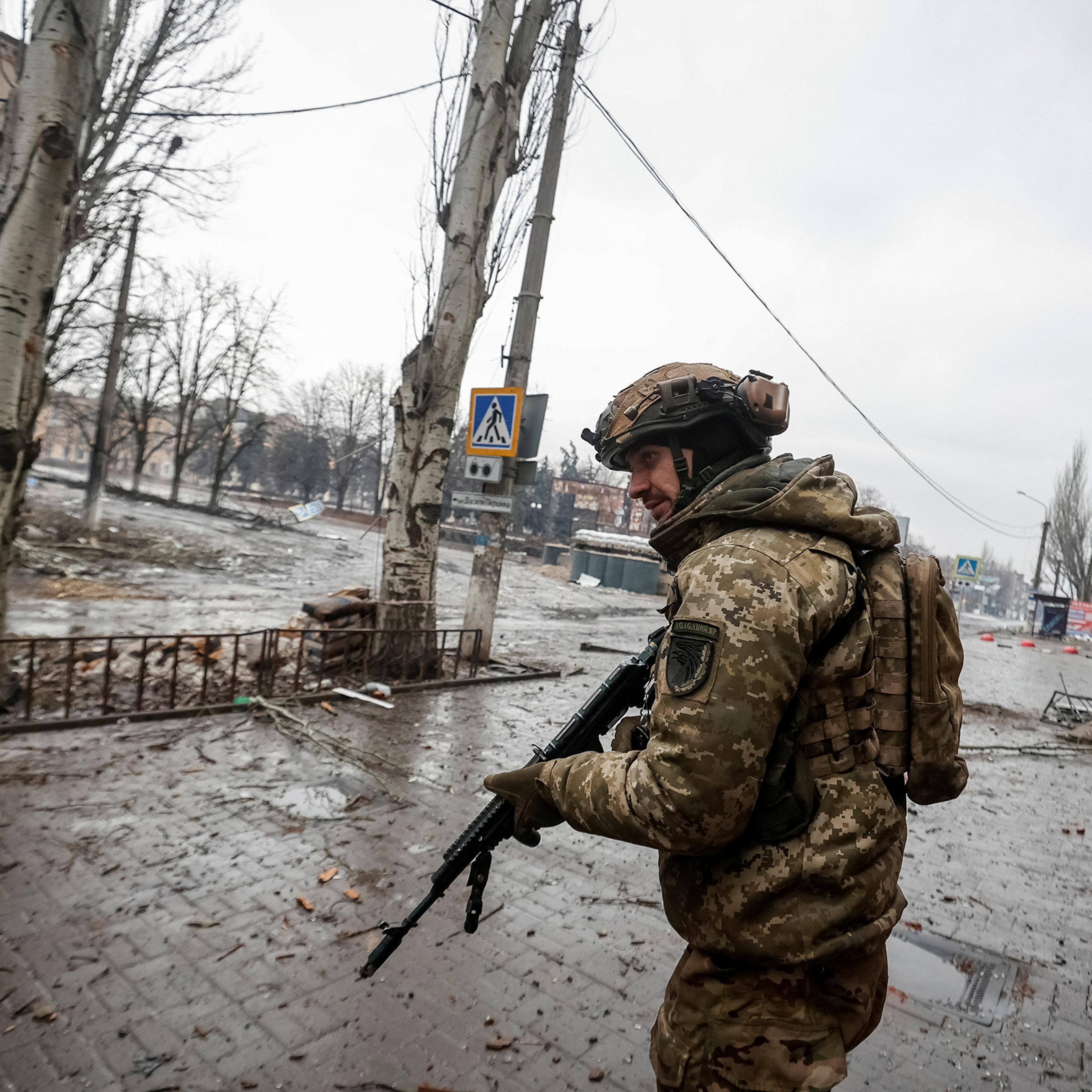 A Ukrainian serviceman walks an empty street, as Russia's attack on Ukraine continues, in the front line city of Bakhmut, in Donetsk region, Ukraine, on Feb. 25.