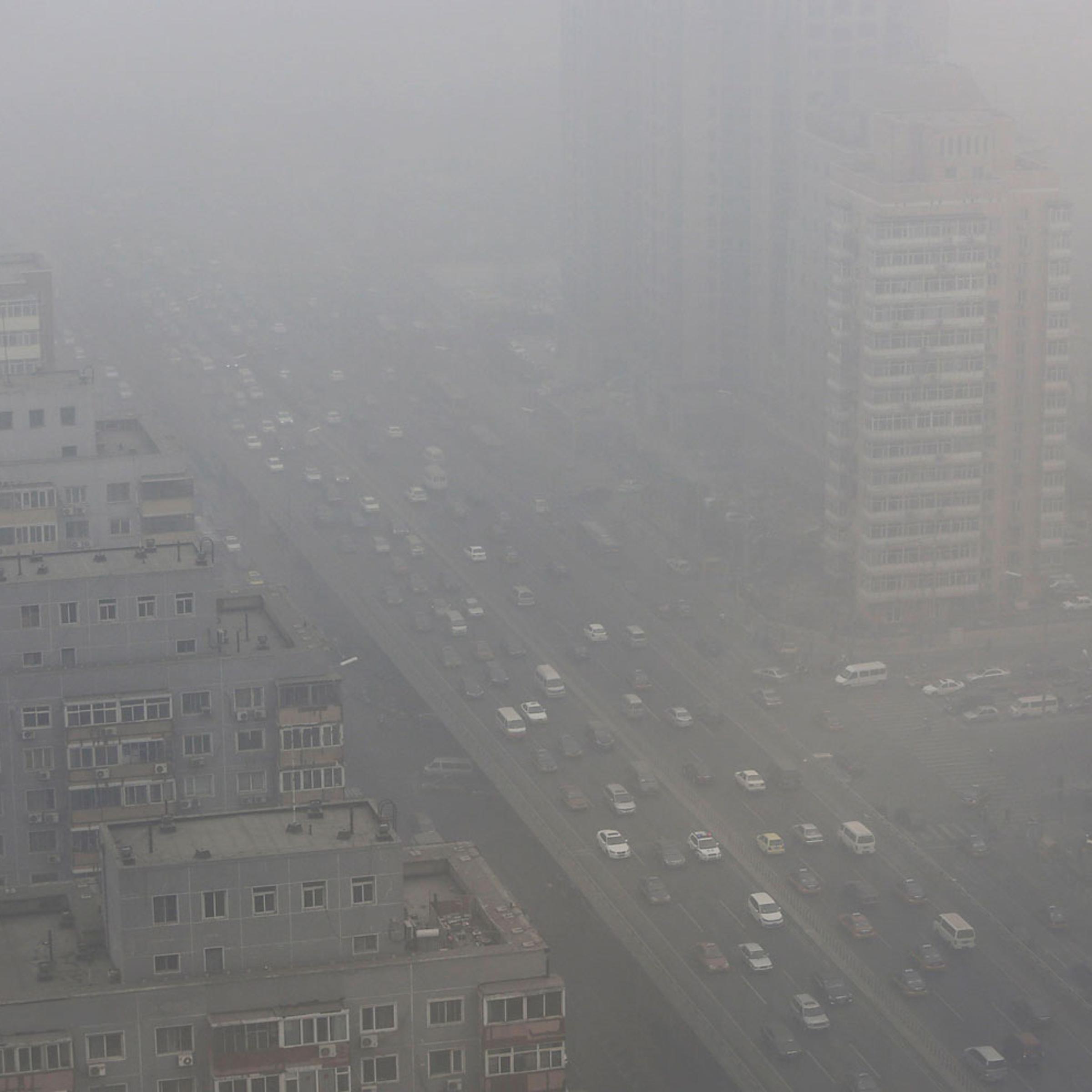 Cars drive on the Three Ring Road amid the heavy haze in Beijing, Feb. 26, 2014.