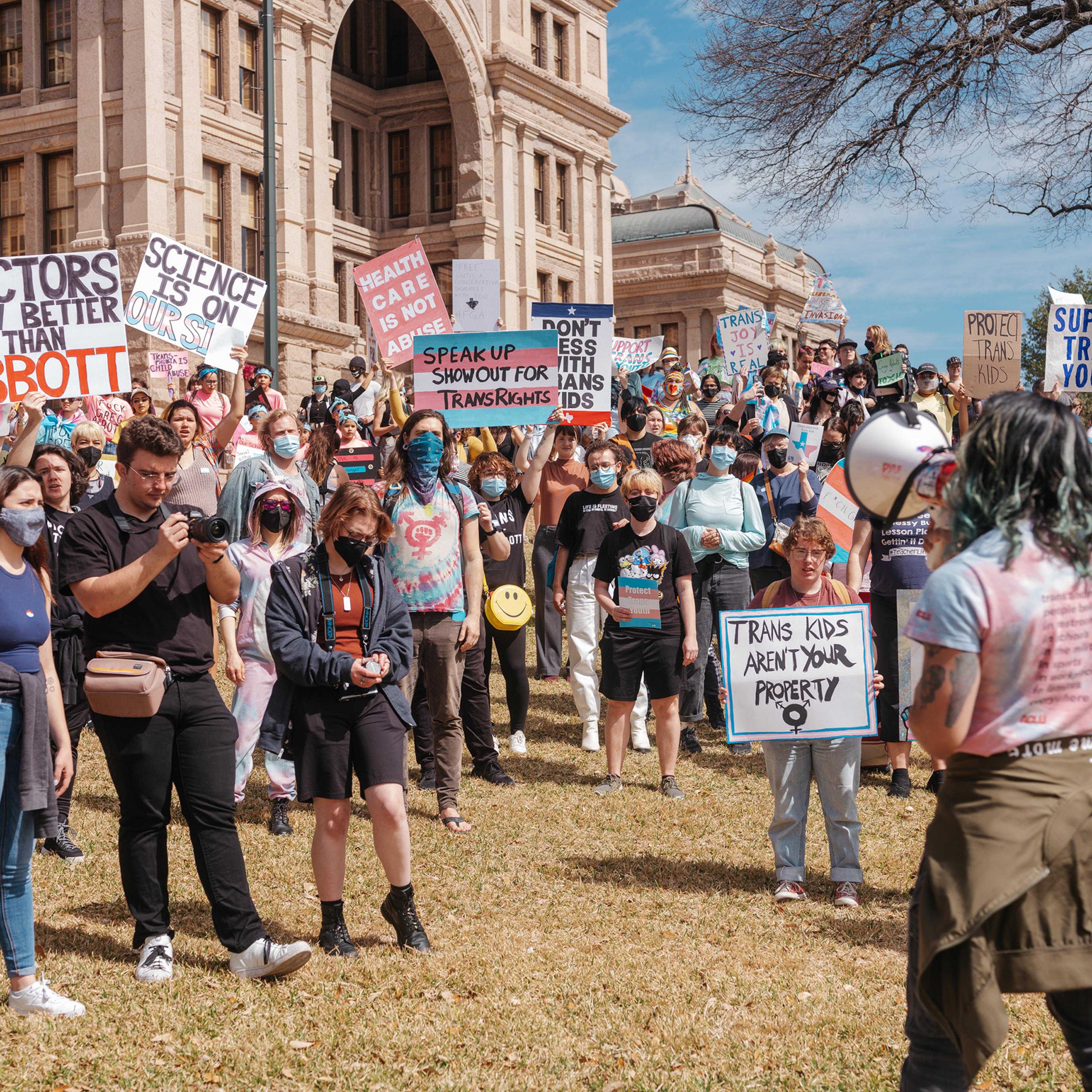 Demonstrators protest a Texas policy to regard gender-affirming treatments for transgender youth as "child abuse," at the State Capitol in Austin, March 1, 2022.