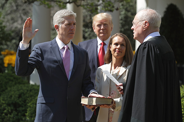 U.S. Supreme Court Associate Justice Anthony Kennedy (R) administers the judicial oath to Judge Neil Gorsuch as his wife Marie Louise Gorsuch holds a bible and President Donald Trump looks on during a ceremony in the Rose Garden at the White House April 