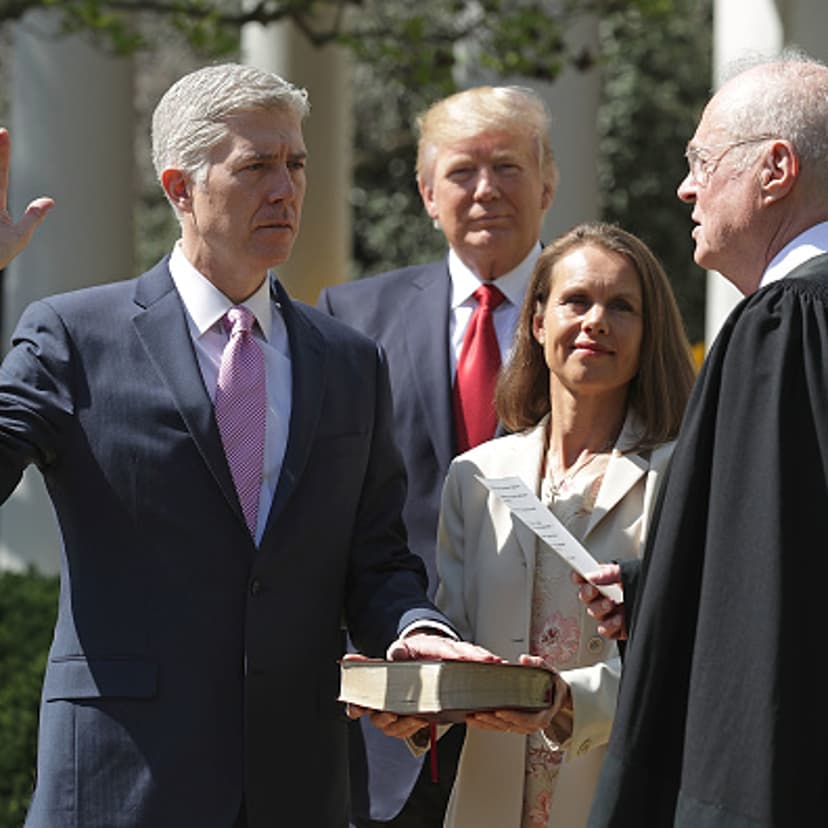 U.S. Supreme Court Associate Justice Anthony Kennedy (R) administers the judicial oath to Judge Neil Gorsuch as his wife Marie Louise Gorsuch holds a bible and President Donald Trump looks on during a ceremony in the Rose Garden at the White House April