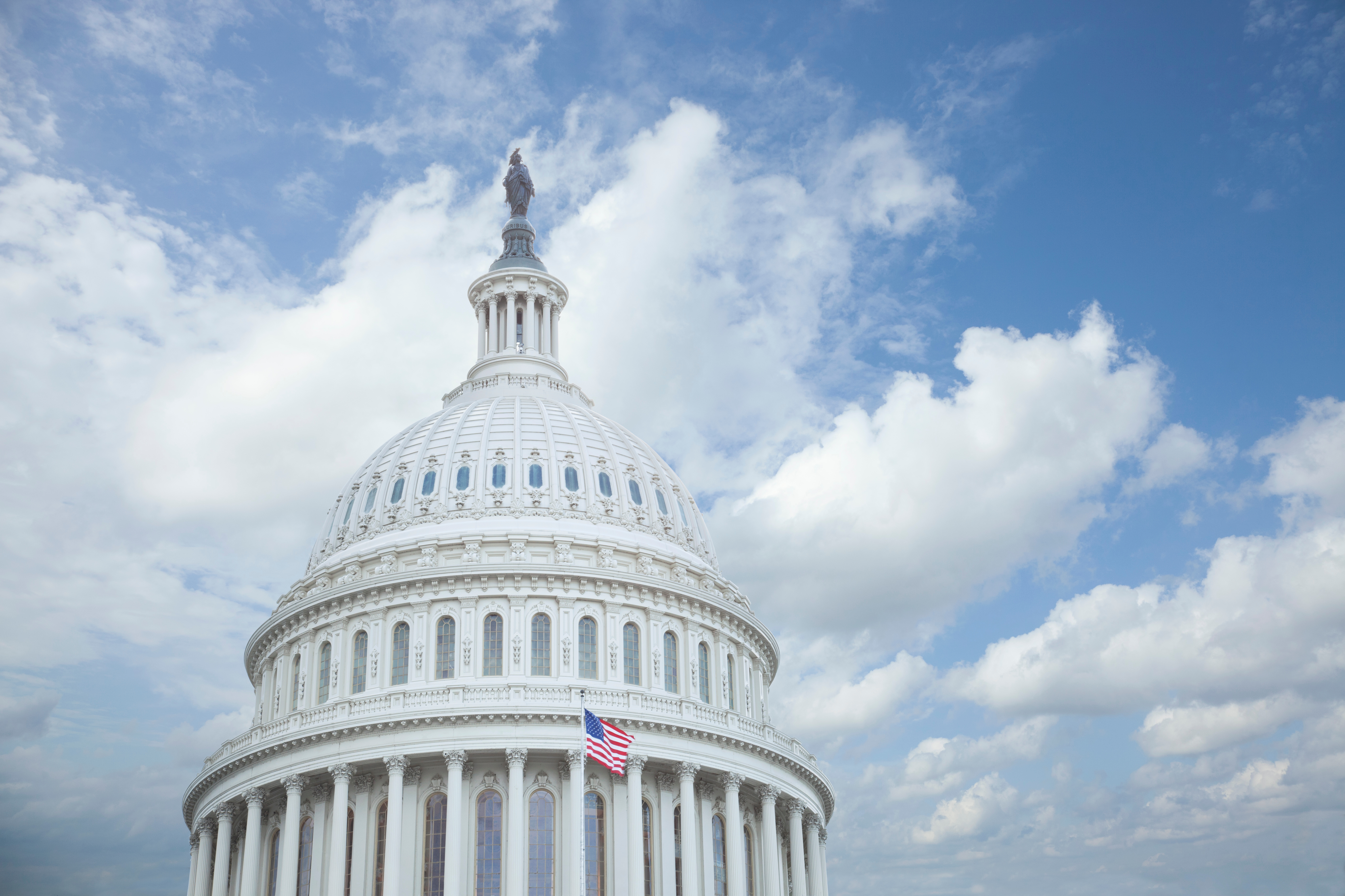 Low Angle View Of United States Capitol Against Cloudy Sky In City