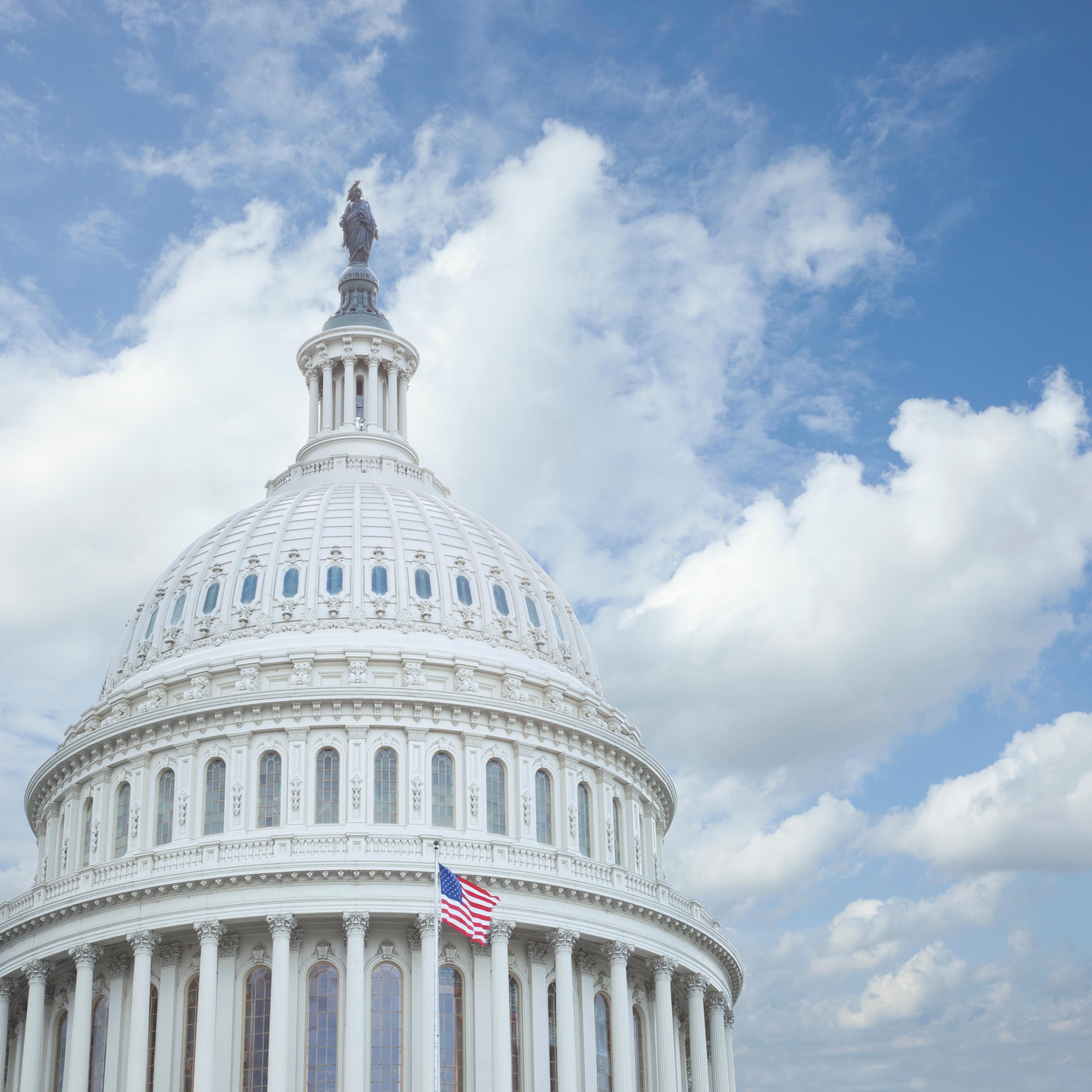 Low Angle View Of United States Capitol Against Cloudy Sky In City