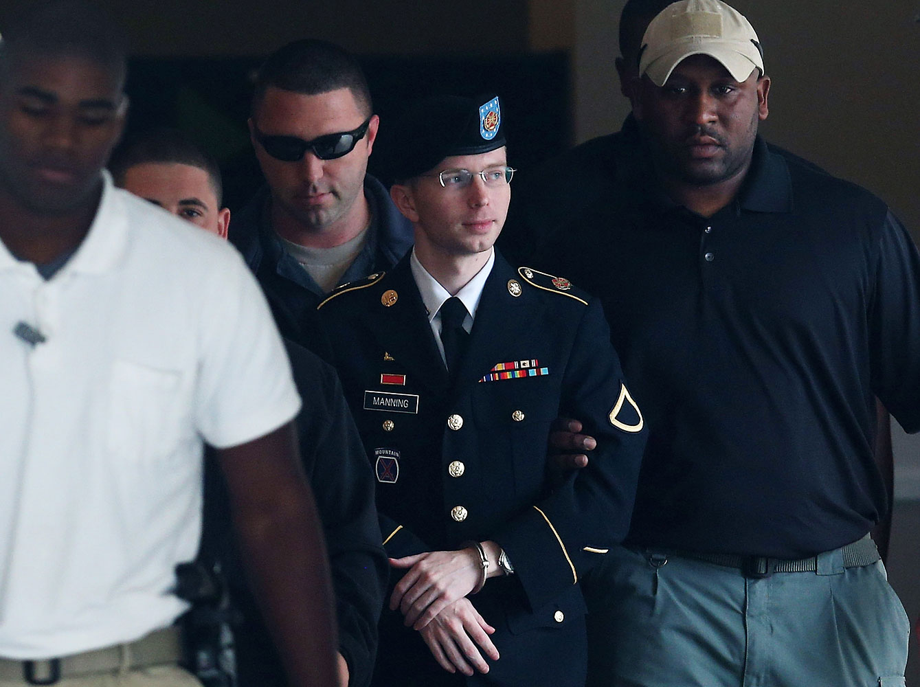 Army Private First Class Bradley Manning is escorted out of a military court facilityÊduring the sentencing phase of his trial Aug. 20, 2013 in Fort Meade, Maryland.