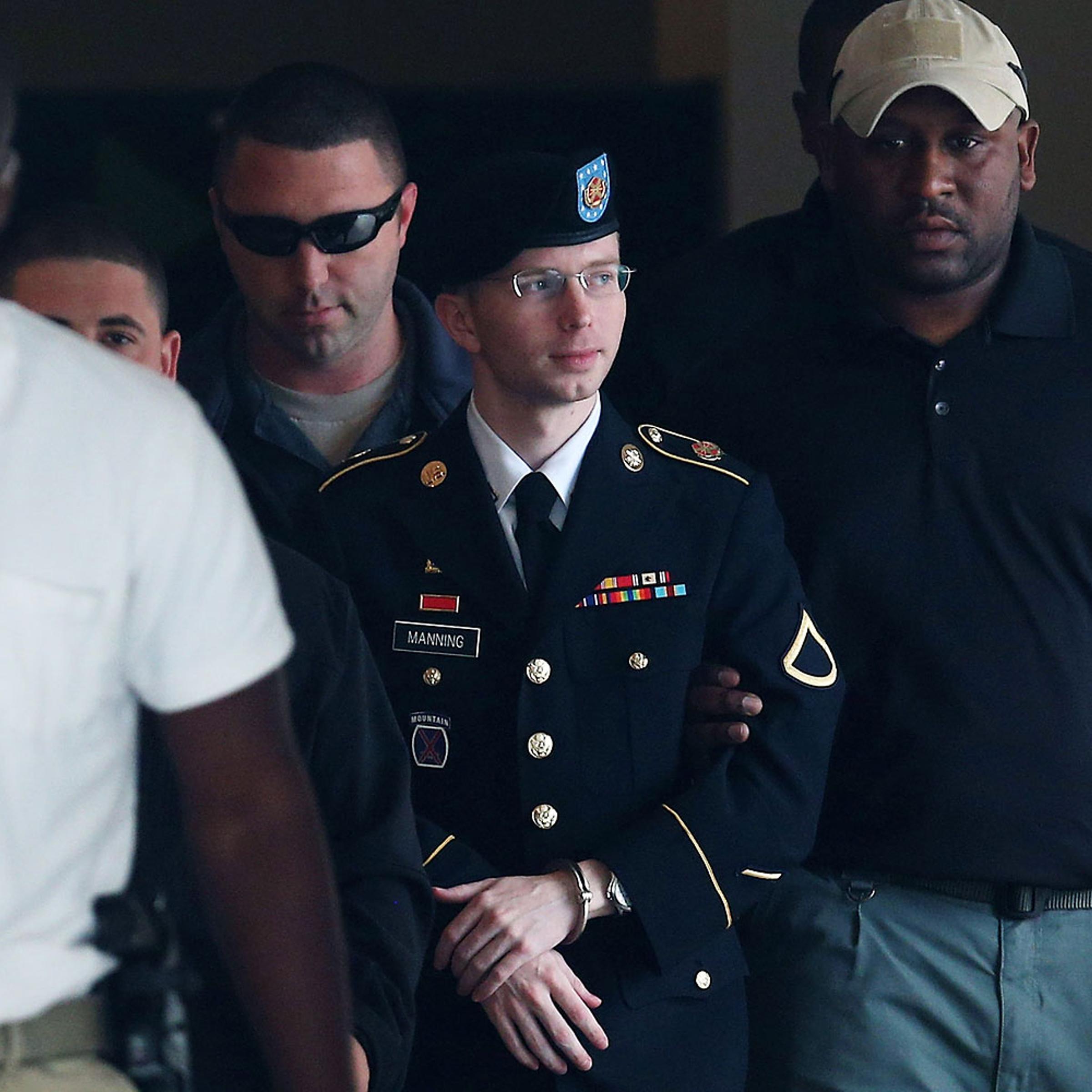 Army Private First Class Bradley Manning is escorted out of a military court facilityÊduring the sentencing phase of his trial Aug. 20, 2013 in Fort Meade, Maryland.