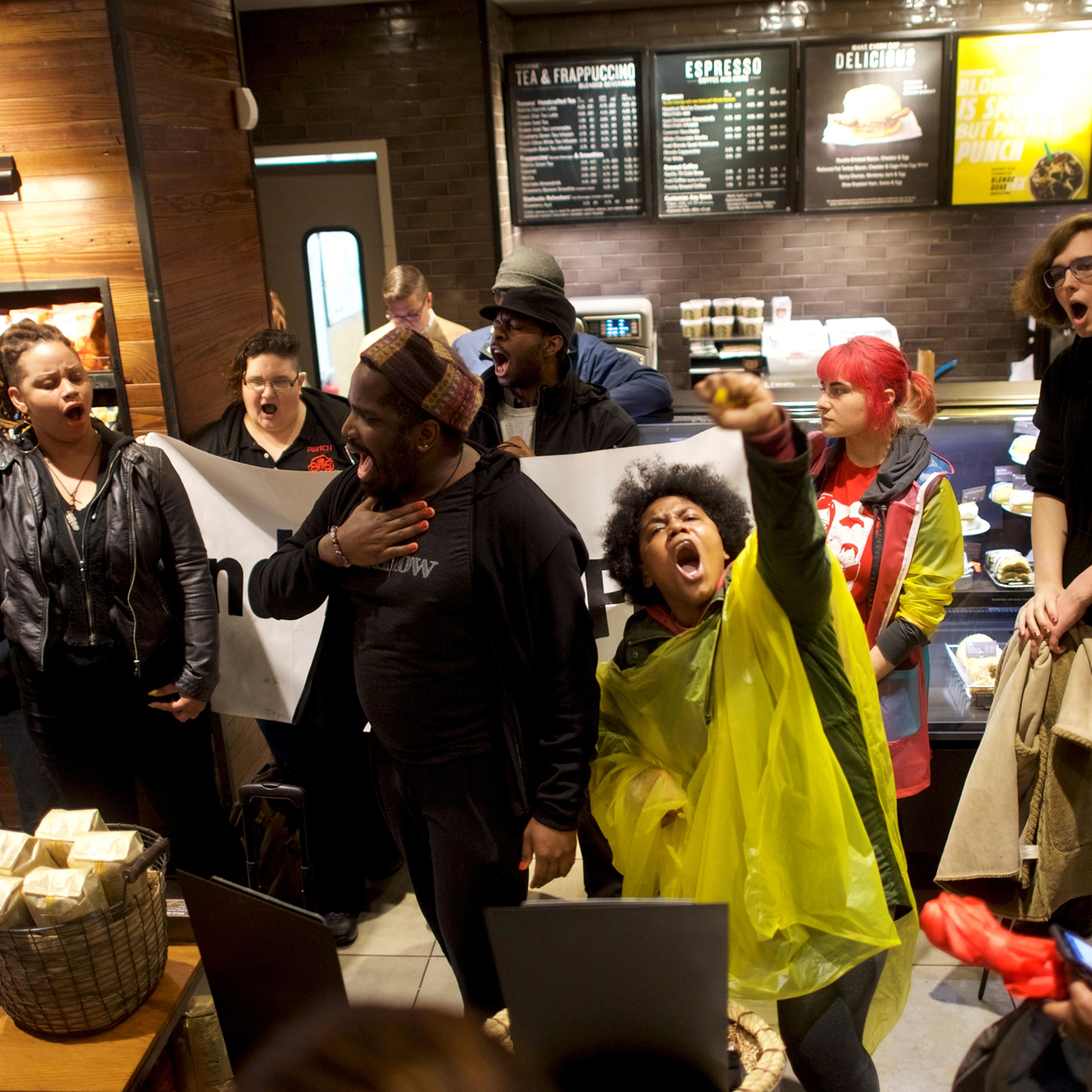Protesters demonstrate inside a Center City Starbucks, where two black men were arrested, in Philadelphia