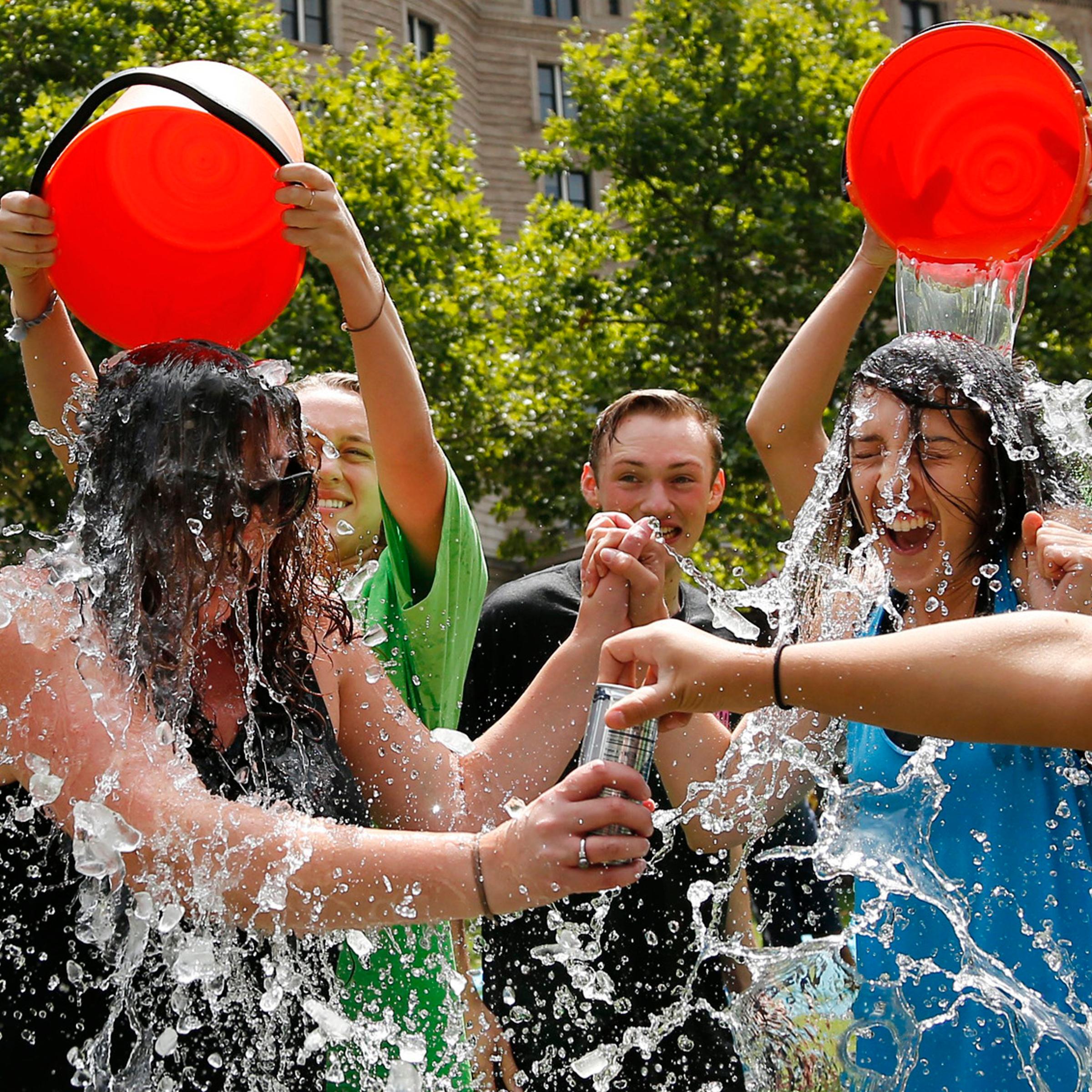 Two women get doused during the ice bucket challenge at Boston's Copley Square on Aug. 7, 2014.