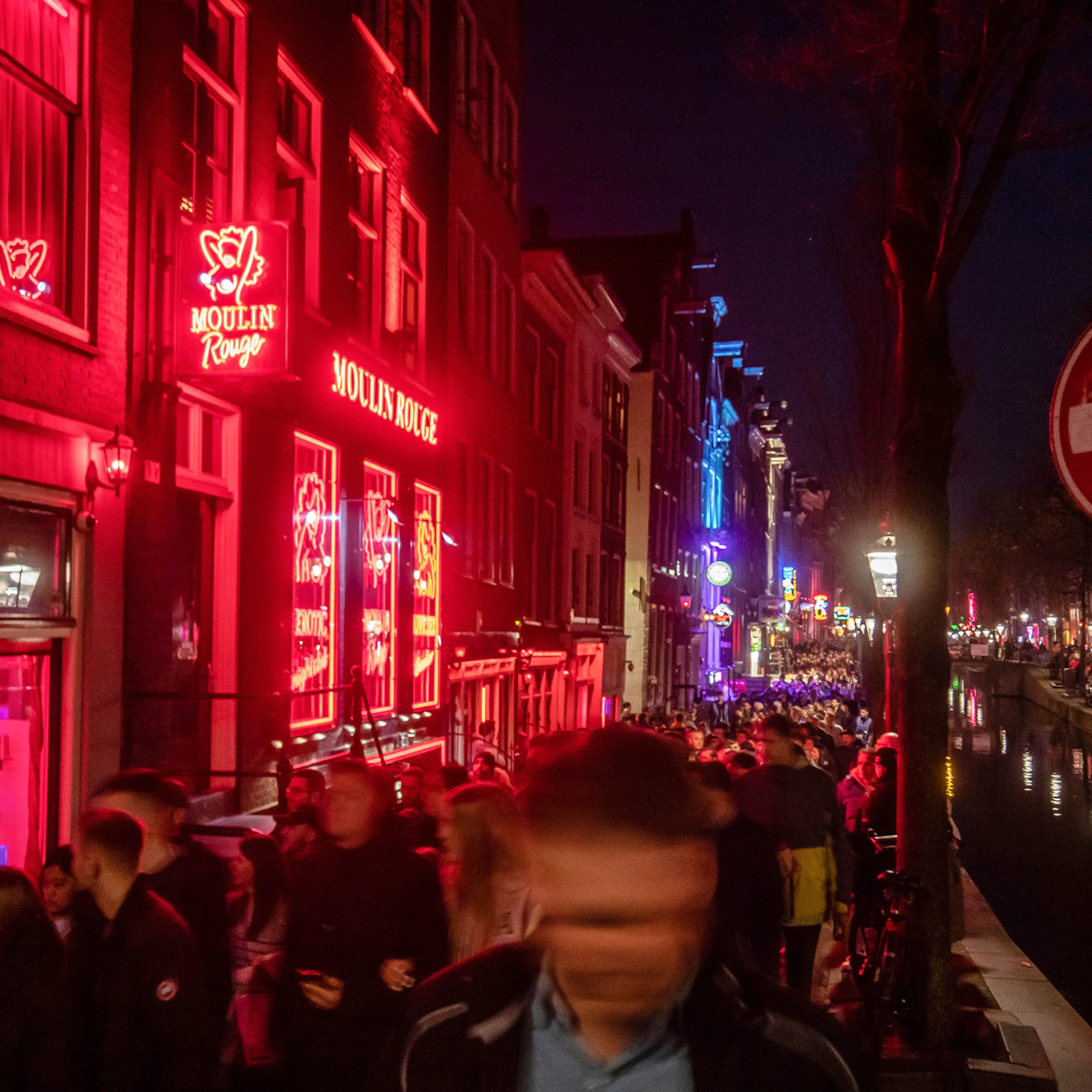 Tourists along the Oudezijds Achterburgwal canal in the red light district in Amsterdam, Netherlands, on April 9. Amsterdam has begun a “Stay Away” campaign aimed at keeping rowdy visitors from descending upon the city.