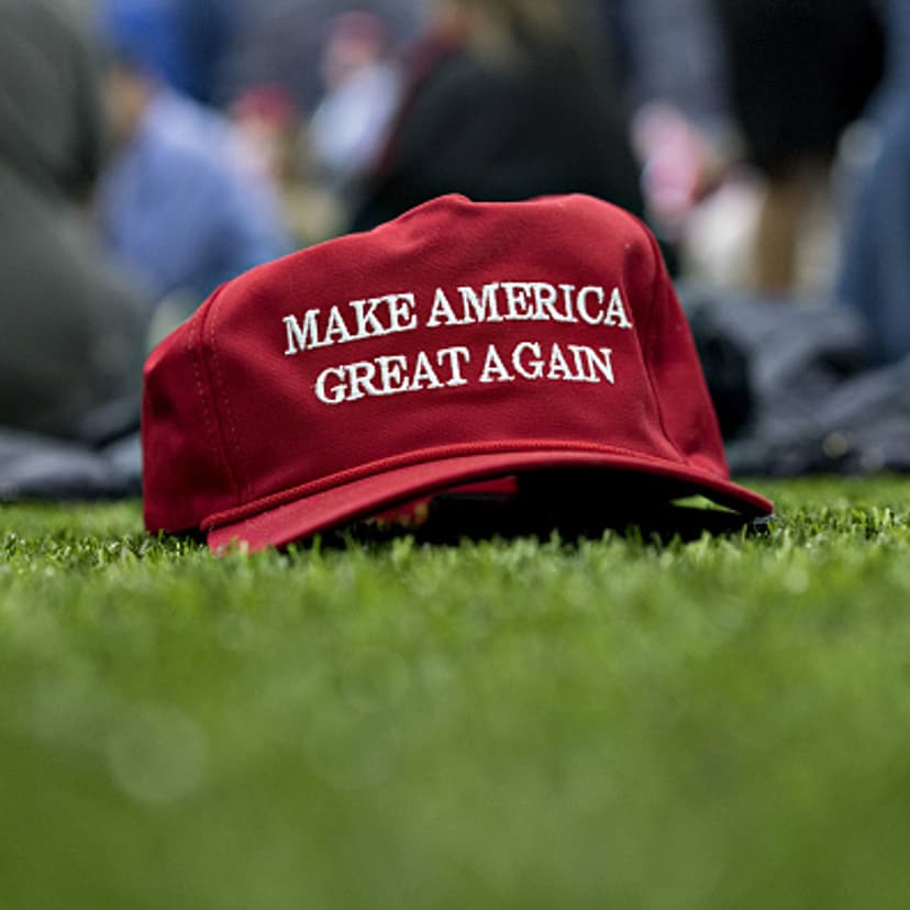 A 'Make America Great Again' hat sits on the ground ahead of a speech by U.S. President Donald Trump during a rally in Washington, Michigan, U.S., on Saturday, April 28, 2018.