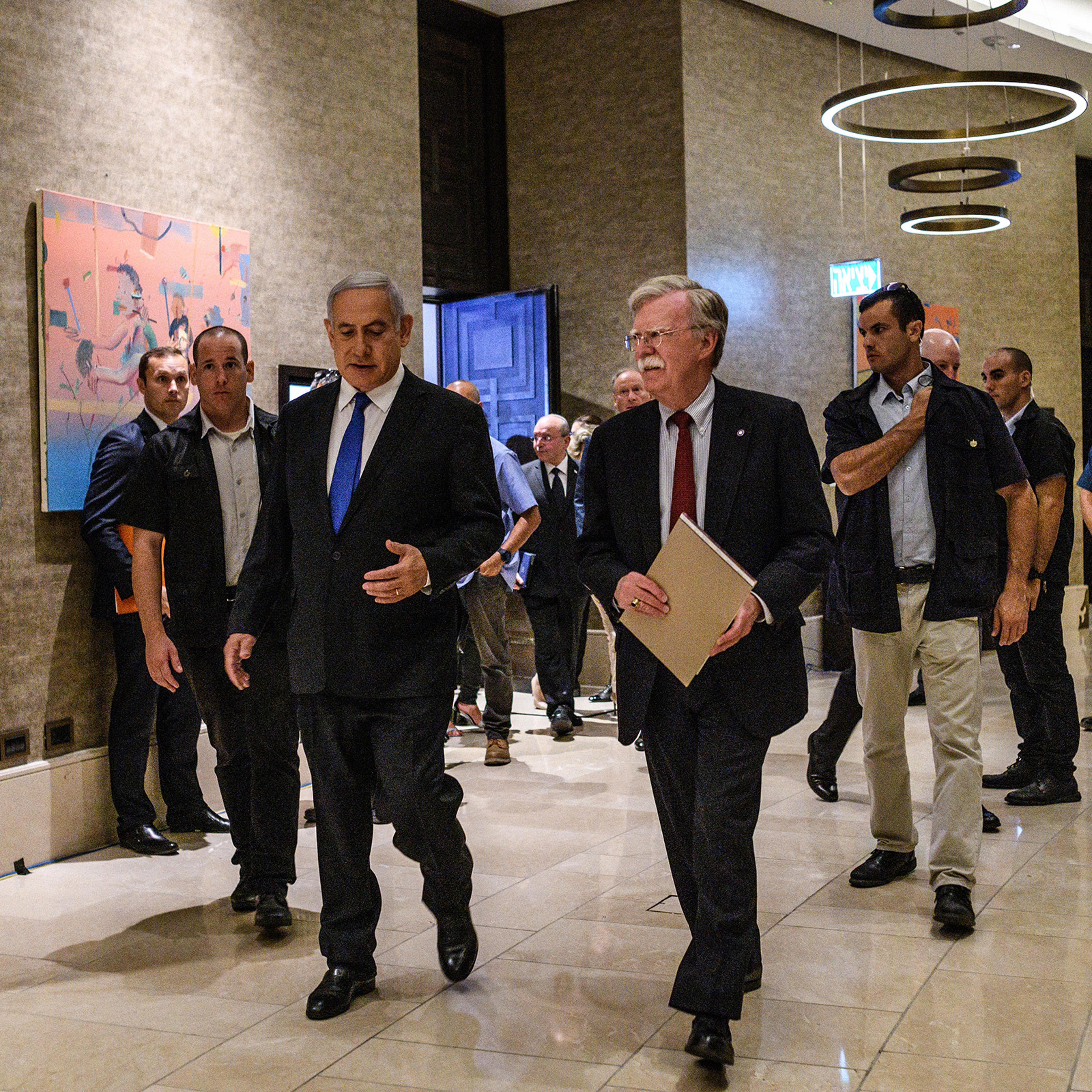 U.S. National Security Adviser John Bolton walks with Israeli Prime Minister Benjamin Netanyahu in Jerusalem in June. Netanyahu met with Bolton, and his Russian counterpart, regarding subjects like Iran and the troops it has in Syria, which Israel border