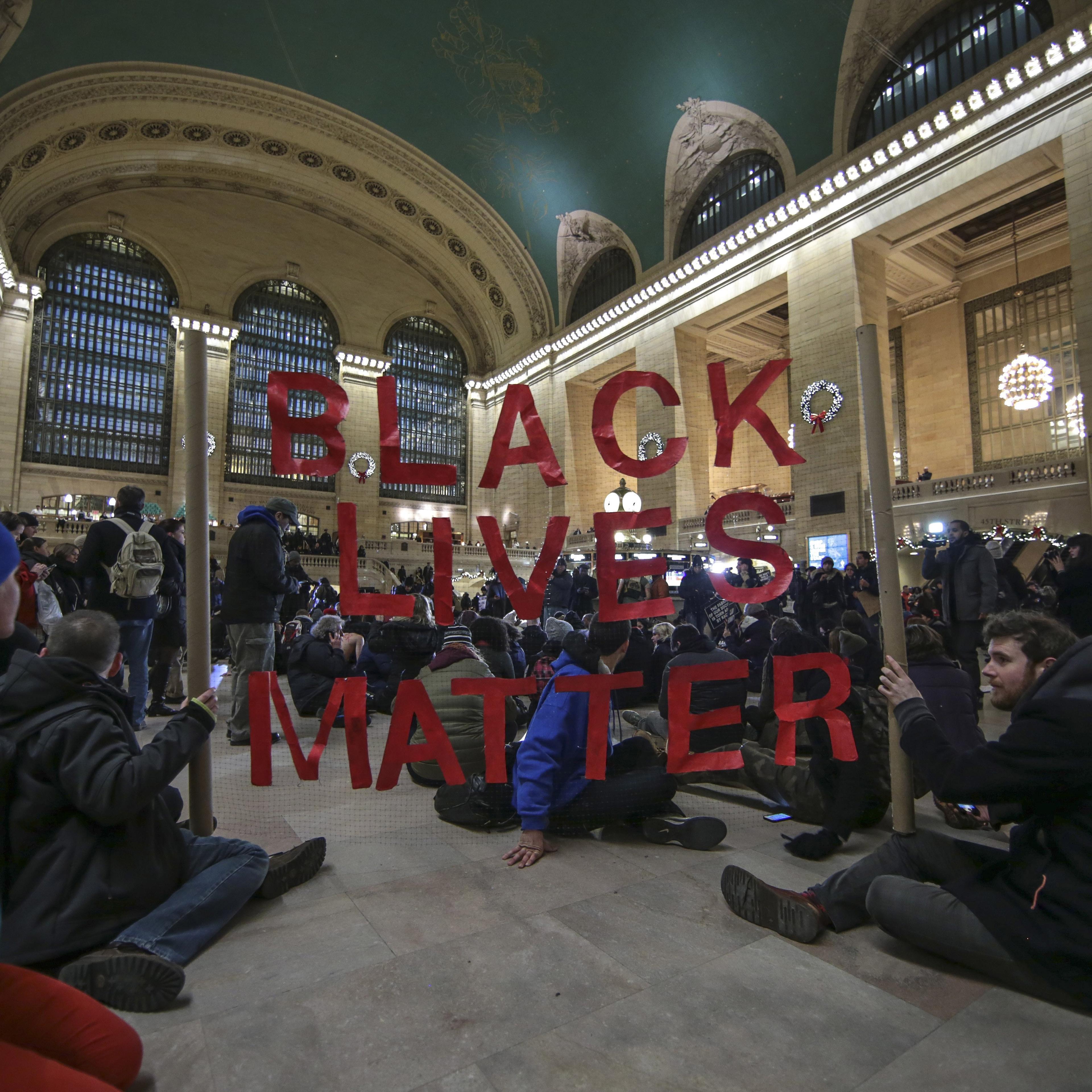 NEW YORK, NY - DECEMBER 7: Protesters hold a banner during a protest at Grand Central Terminal after a grand jury decided not to indict a police officer involved in the death of Eric Garner in July on December 7, 2014 in New York, N.Y. Protests are bein