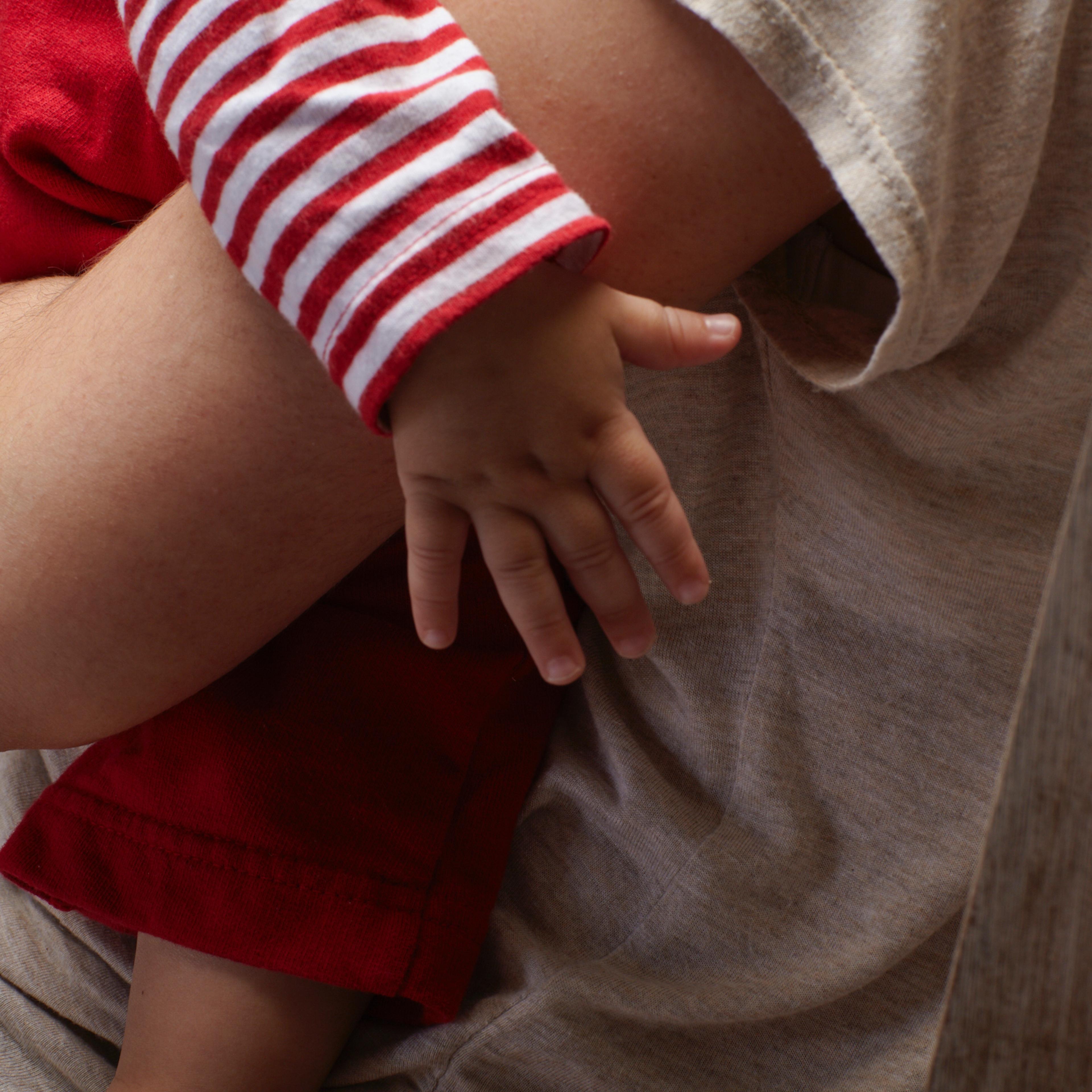 A parent holds their young child