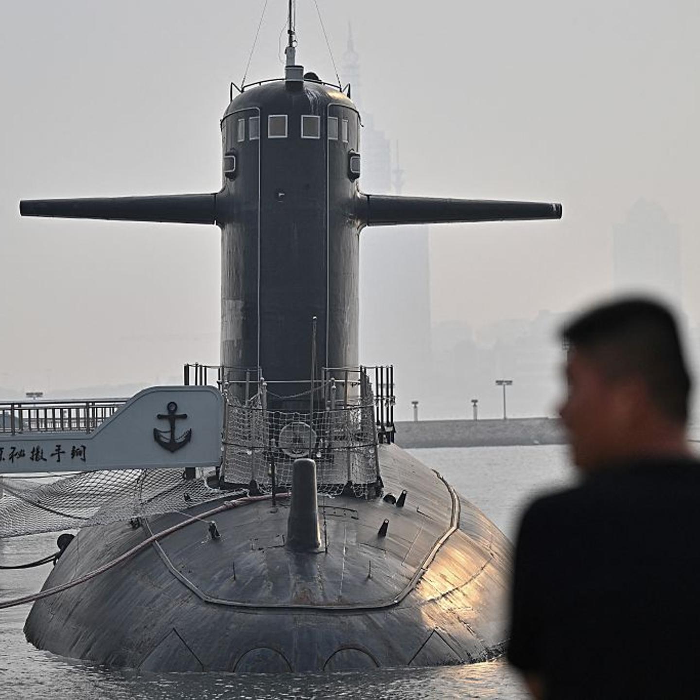 Man looking at a submarine