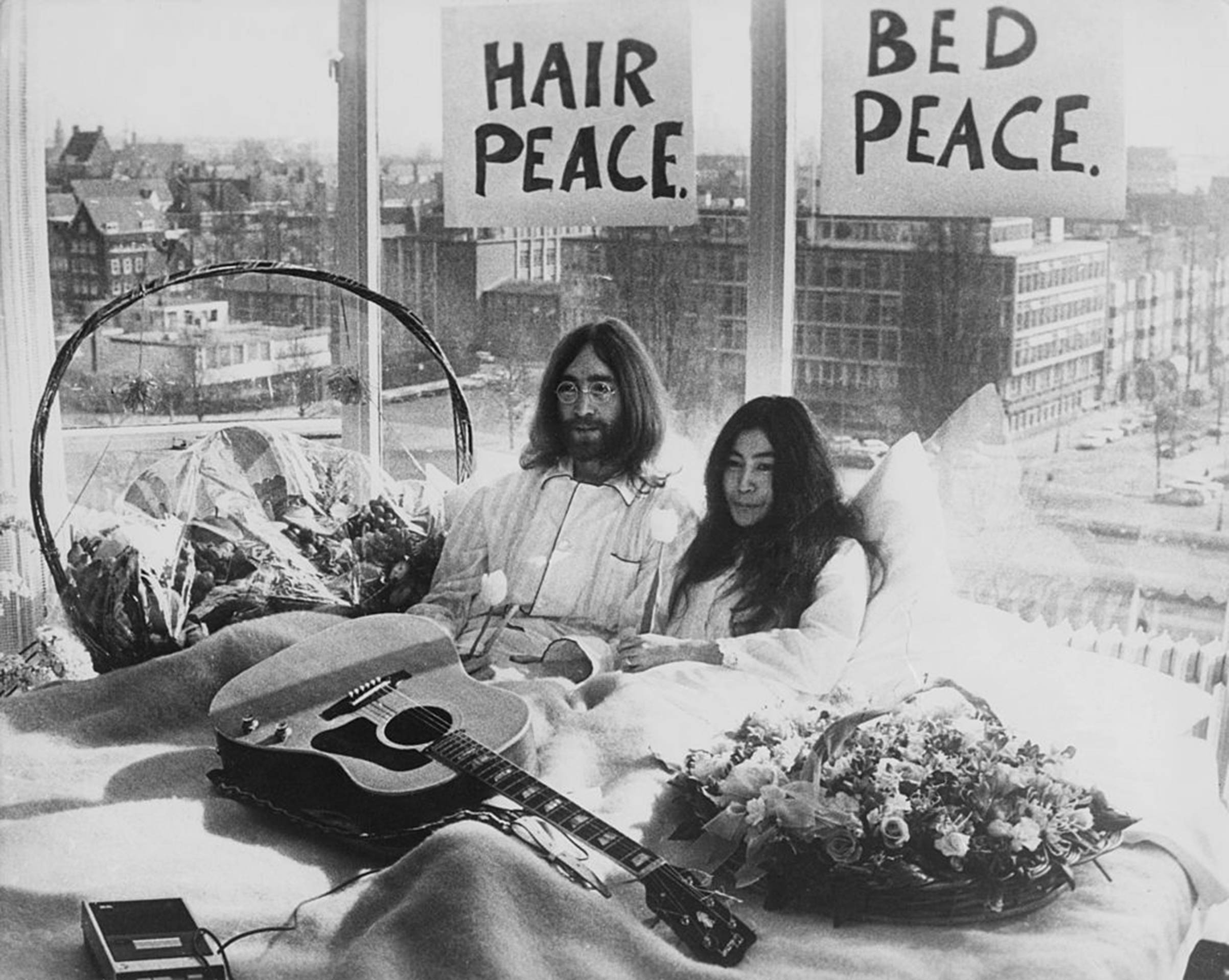 Newly-weds John Lennon of The Beatles and artist Yoko Ono kick-off a bed-in for peace on Mar. 25, 1969, in their suite at the Hilton Amsterdam in The Netherlands.