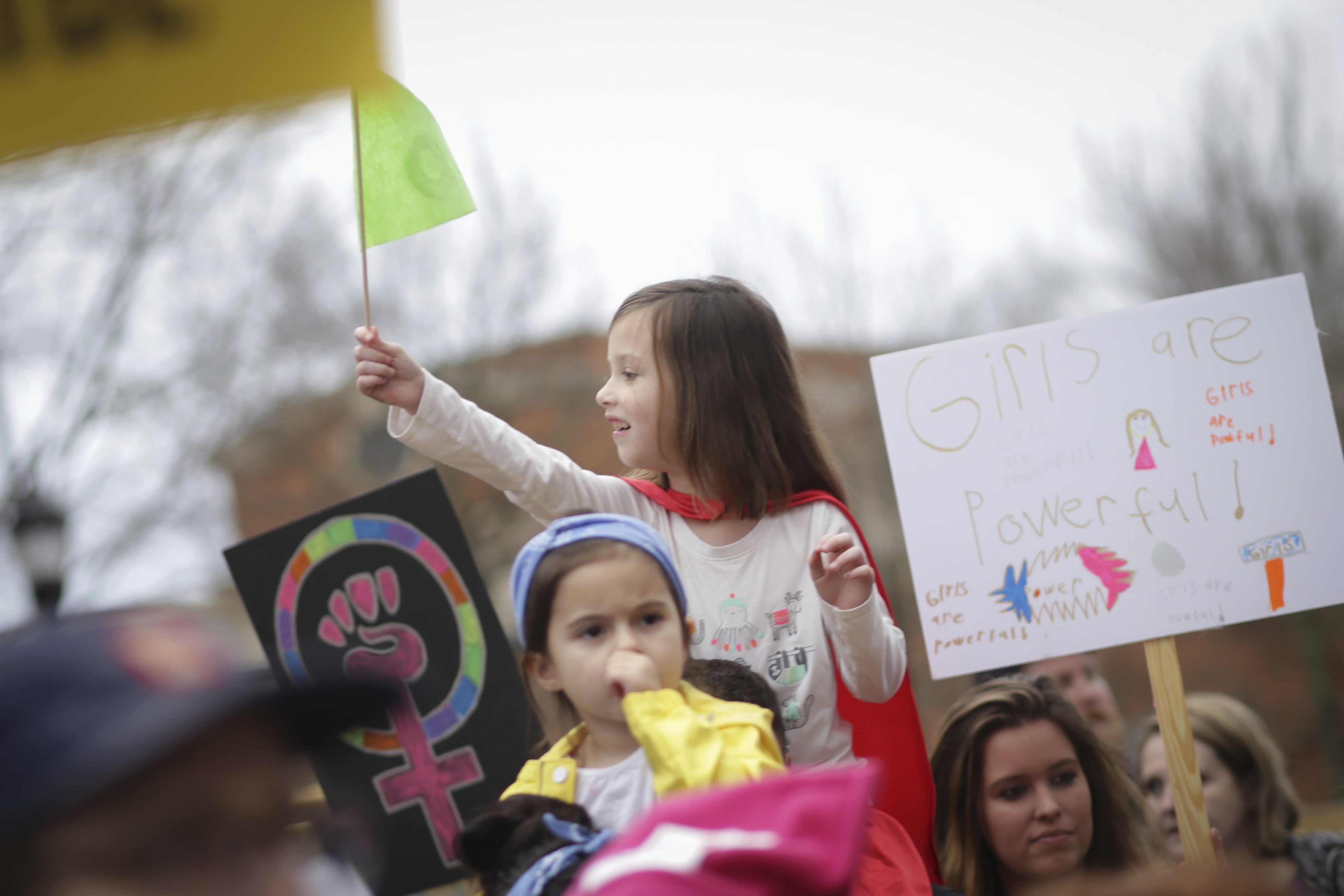 A young girl waves a flag during the Athens Women's March in Athens, Ga., on Jan. 21, 2017.