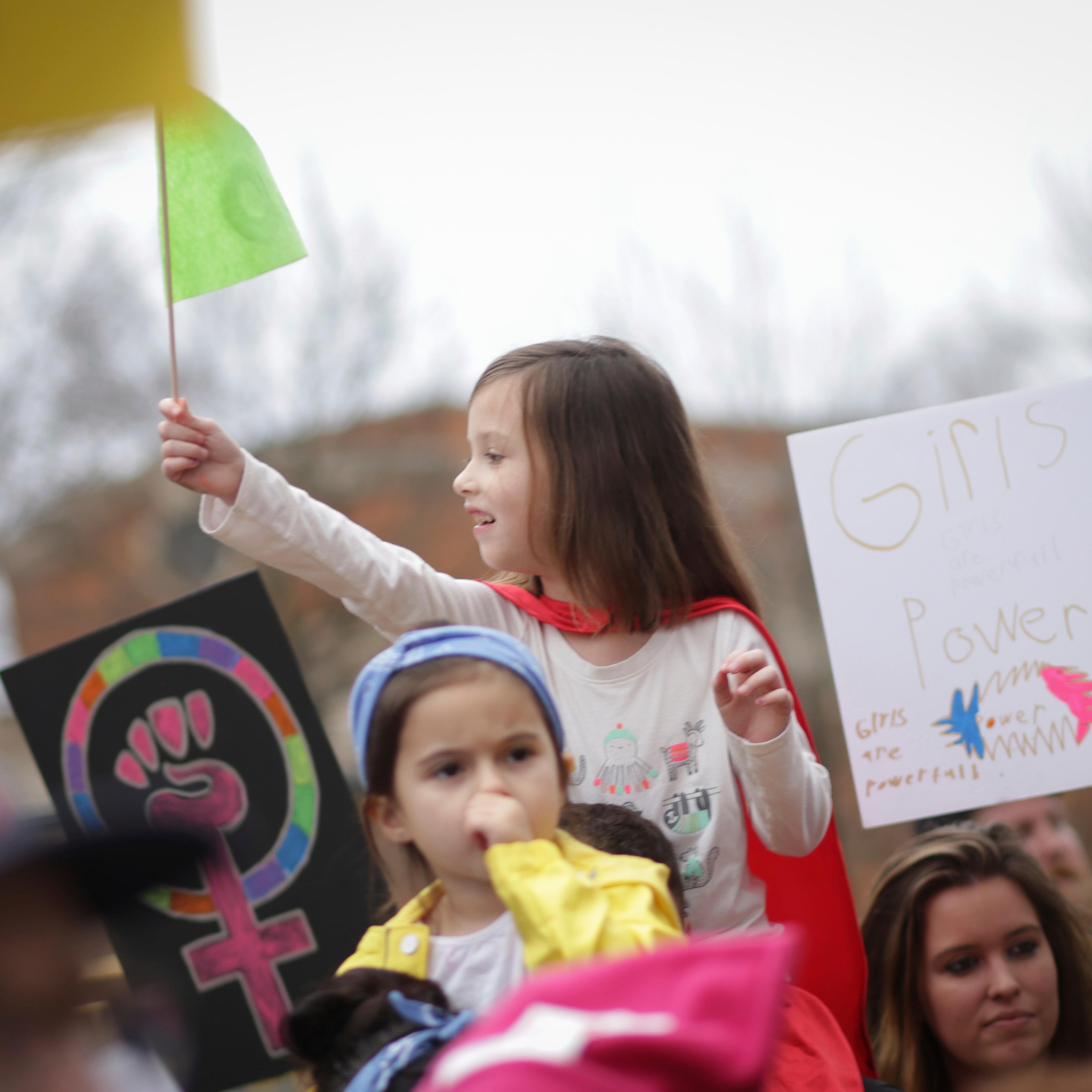 A young girl waves a flag during the Athens Women's March in Athens, Ga., on Jan. 21, 2017.