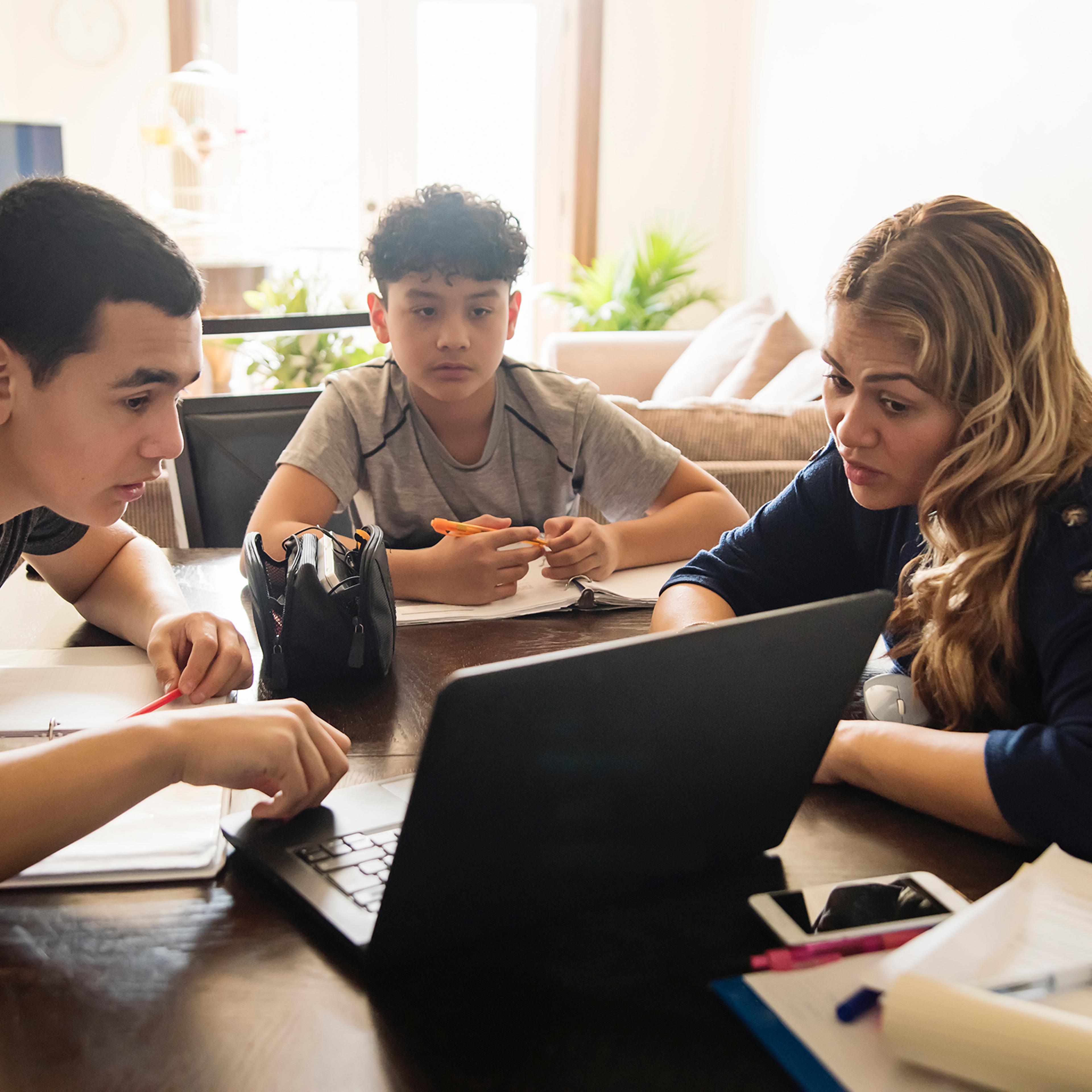 Mother homeschooling teenage boys in self-isolation, Covid-19.