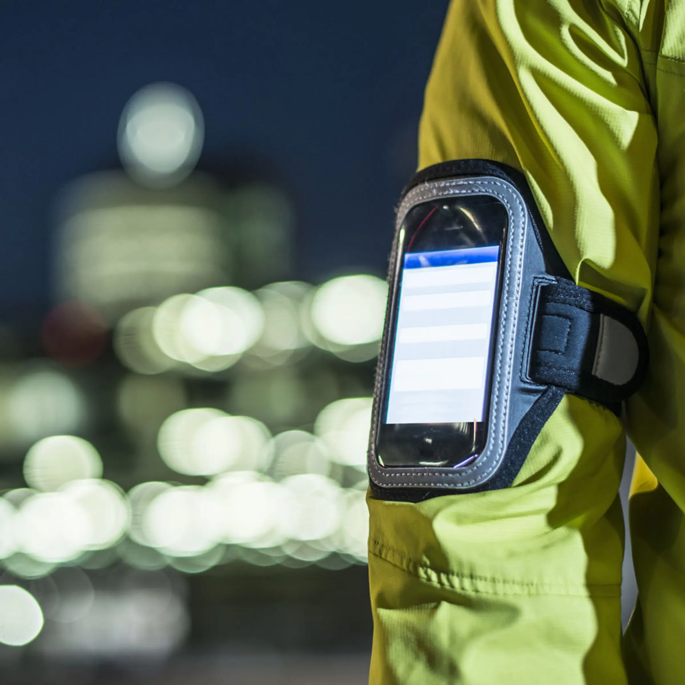 A runner wears a smartphone on his arm.