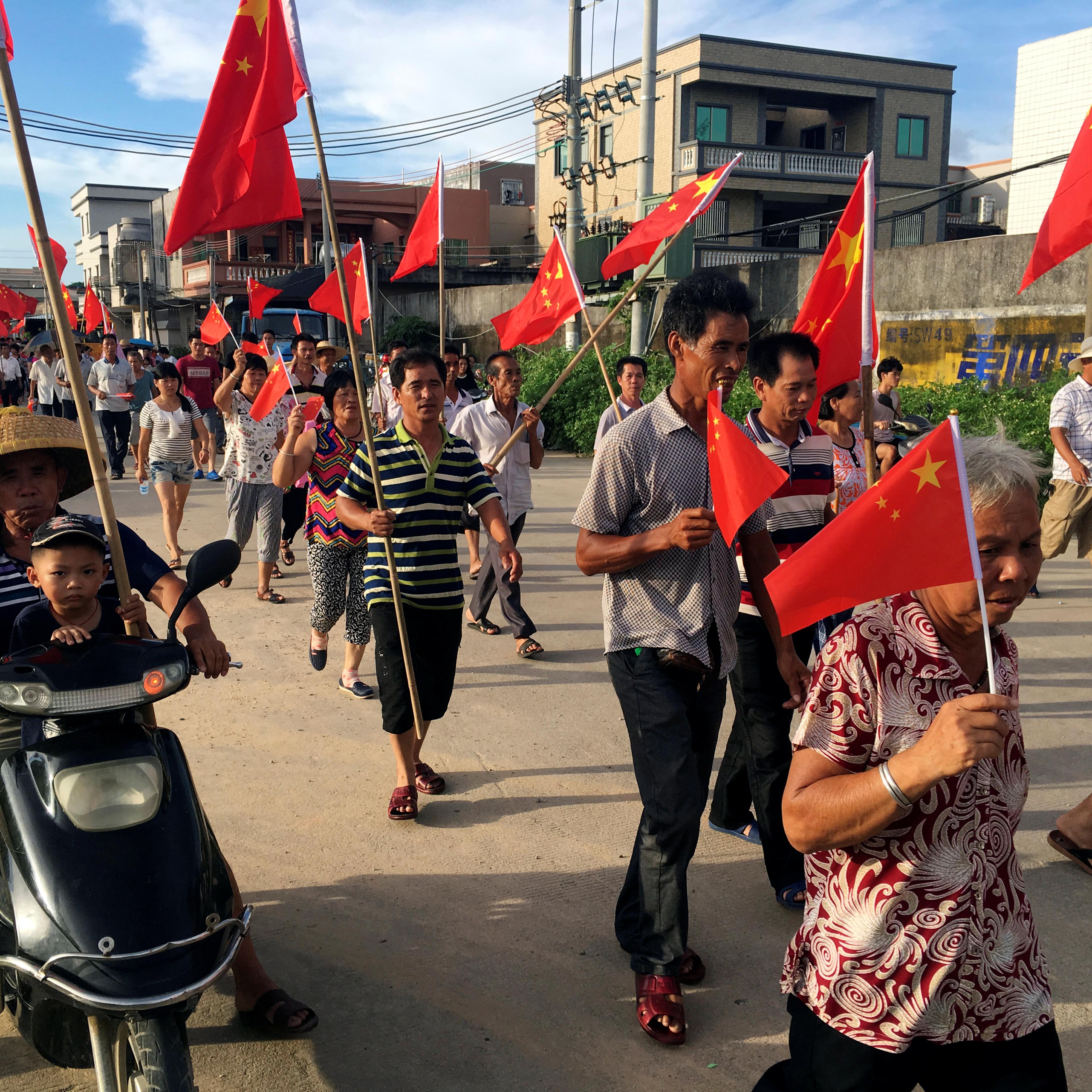 Villagers carrying Chinese national flags protest at Wukan village in China's Guangdong province