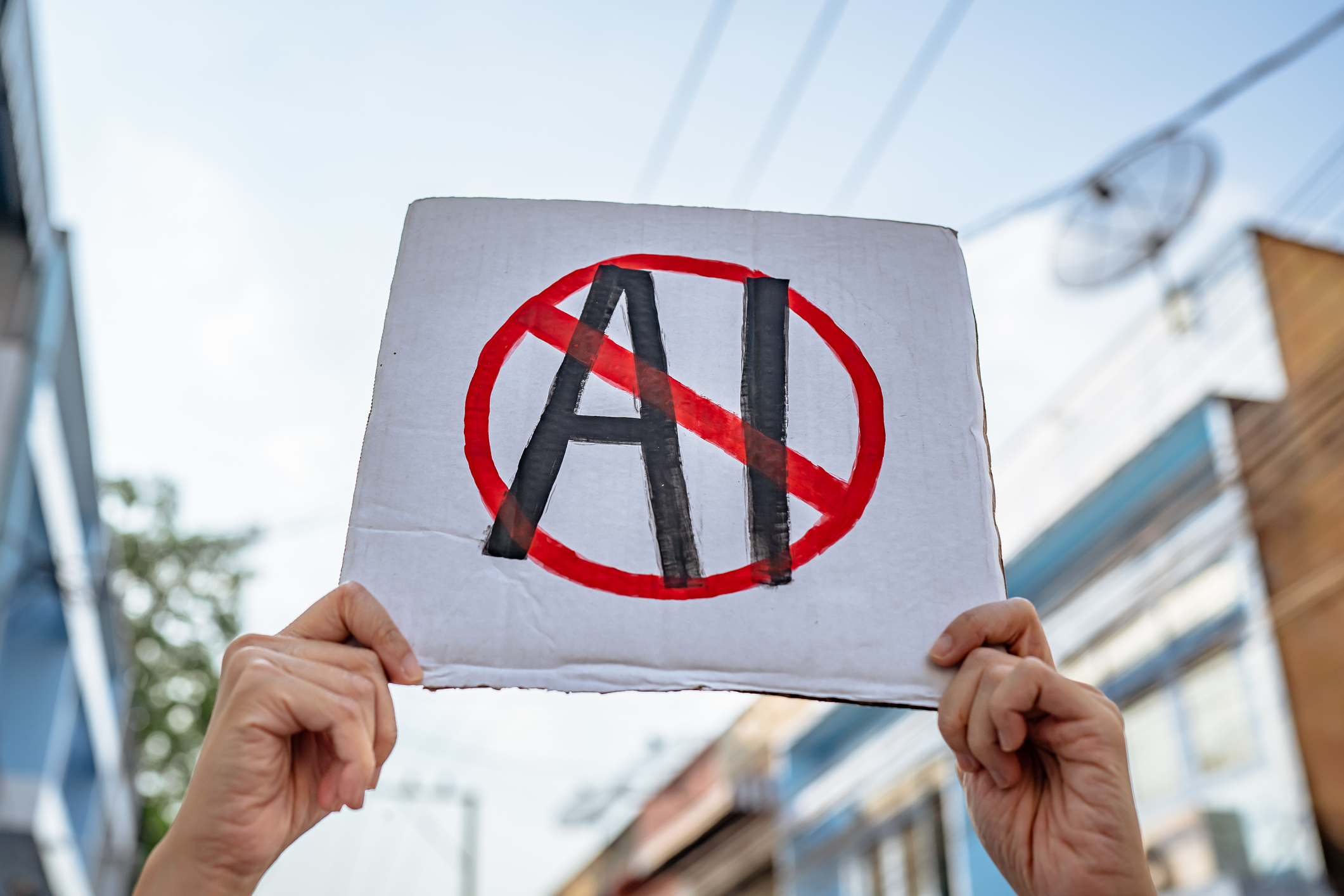 Demonstrator holding "No AI" placard