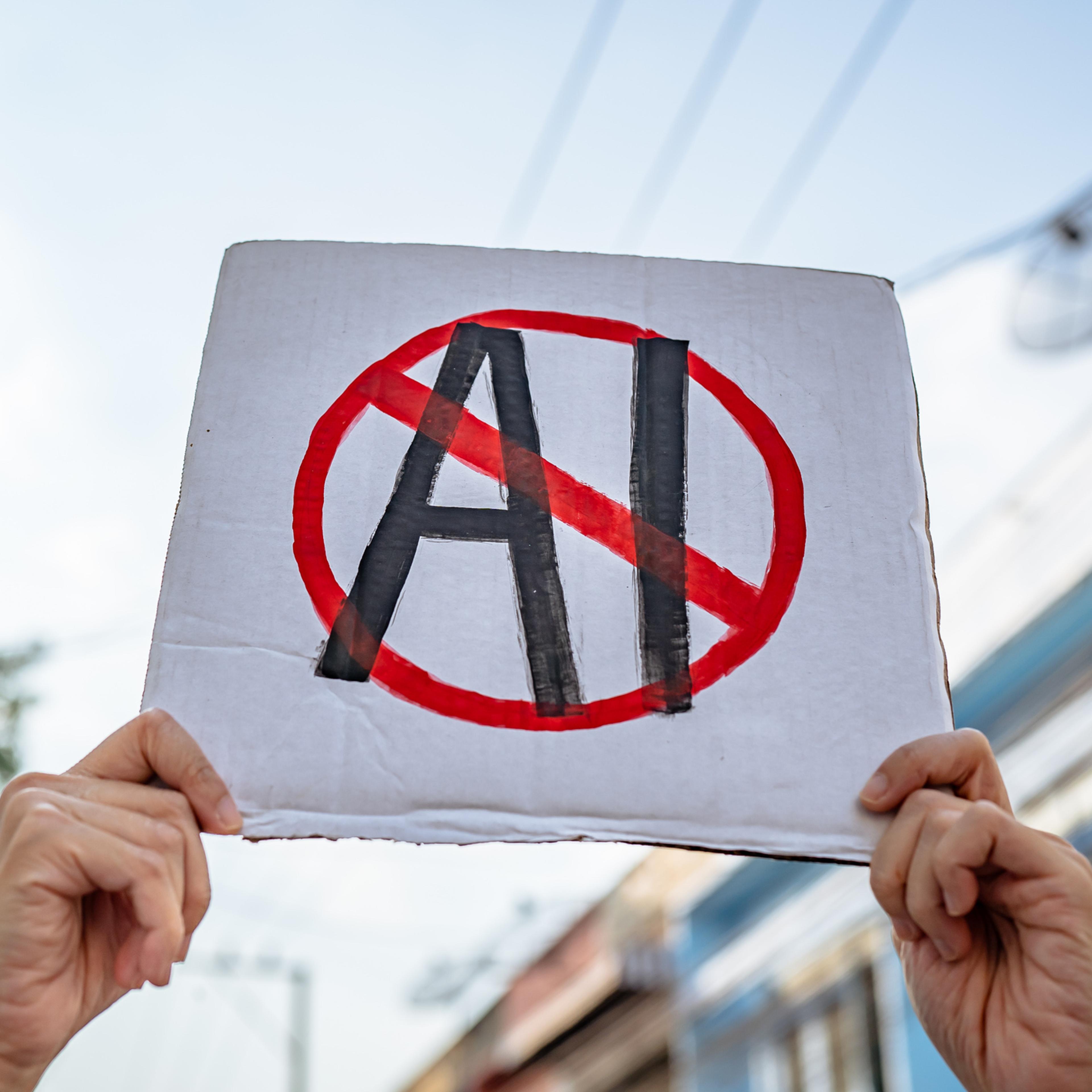Demonstrator holding "No AI" placard