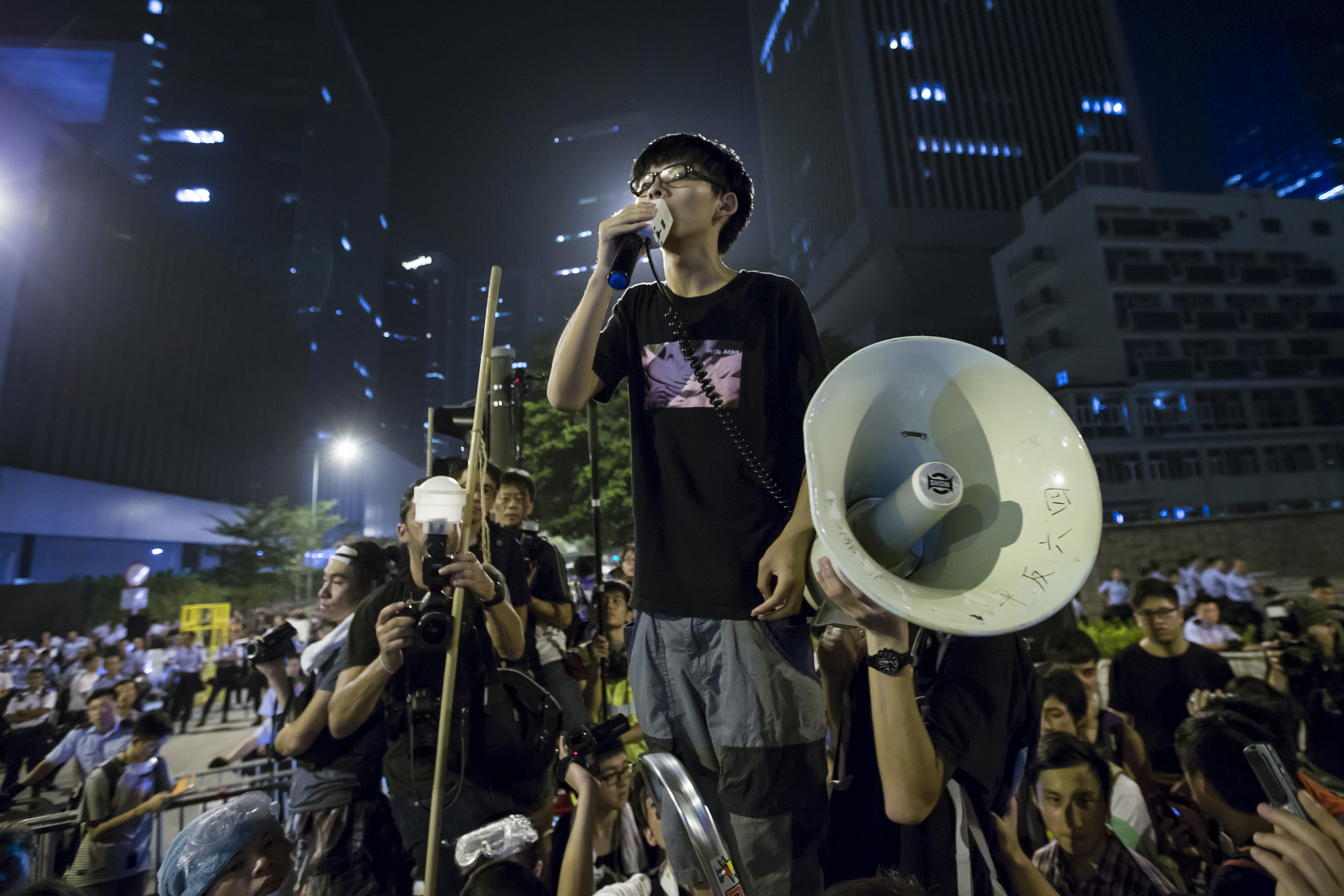 Wong, leader of the student movement, delivers a speech,outside the offices of Hong Kong's Chief Executive Leung Chun-ying in Hong Kong