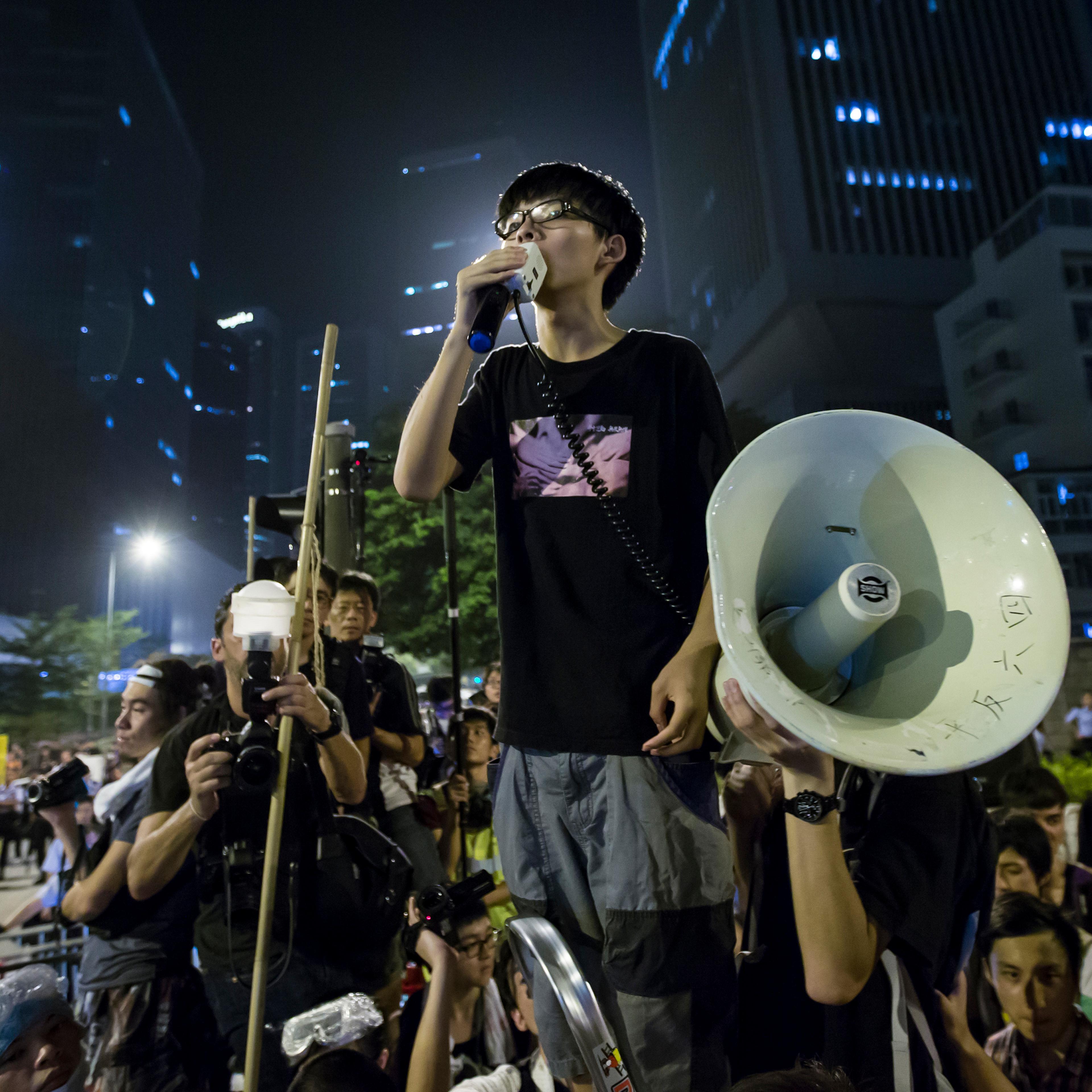 Wong, leader of the student movement, delivers a speech,outside the offices of Hong Kong's Chief Executive Leung Chun-ying in Hong Kong