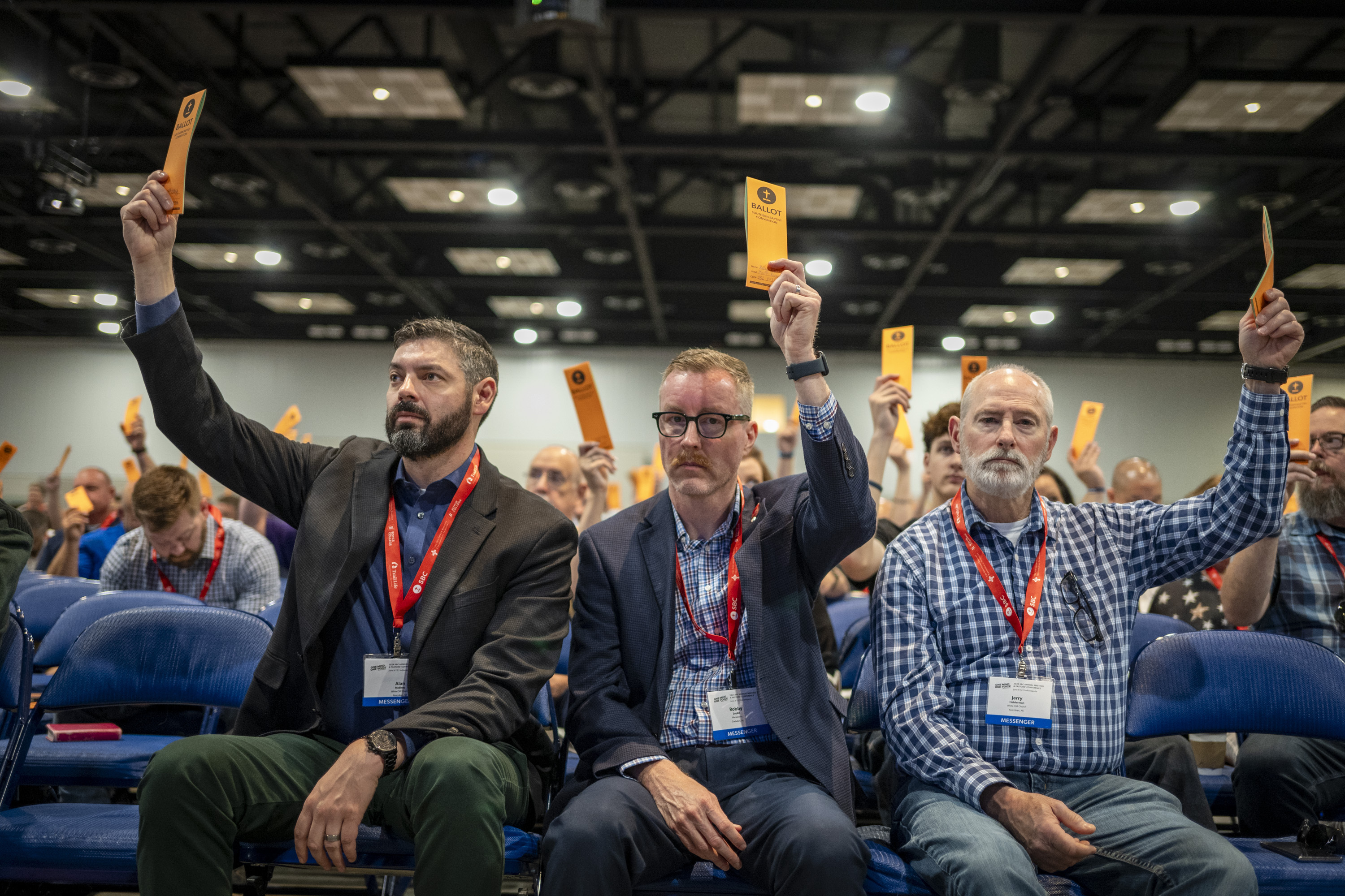 Messengers raise their ballots in support of a motion put up for vote during a Southern Baptist Convention annual meeting Tuesday, June 11, 2024, in Indianapolis