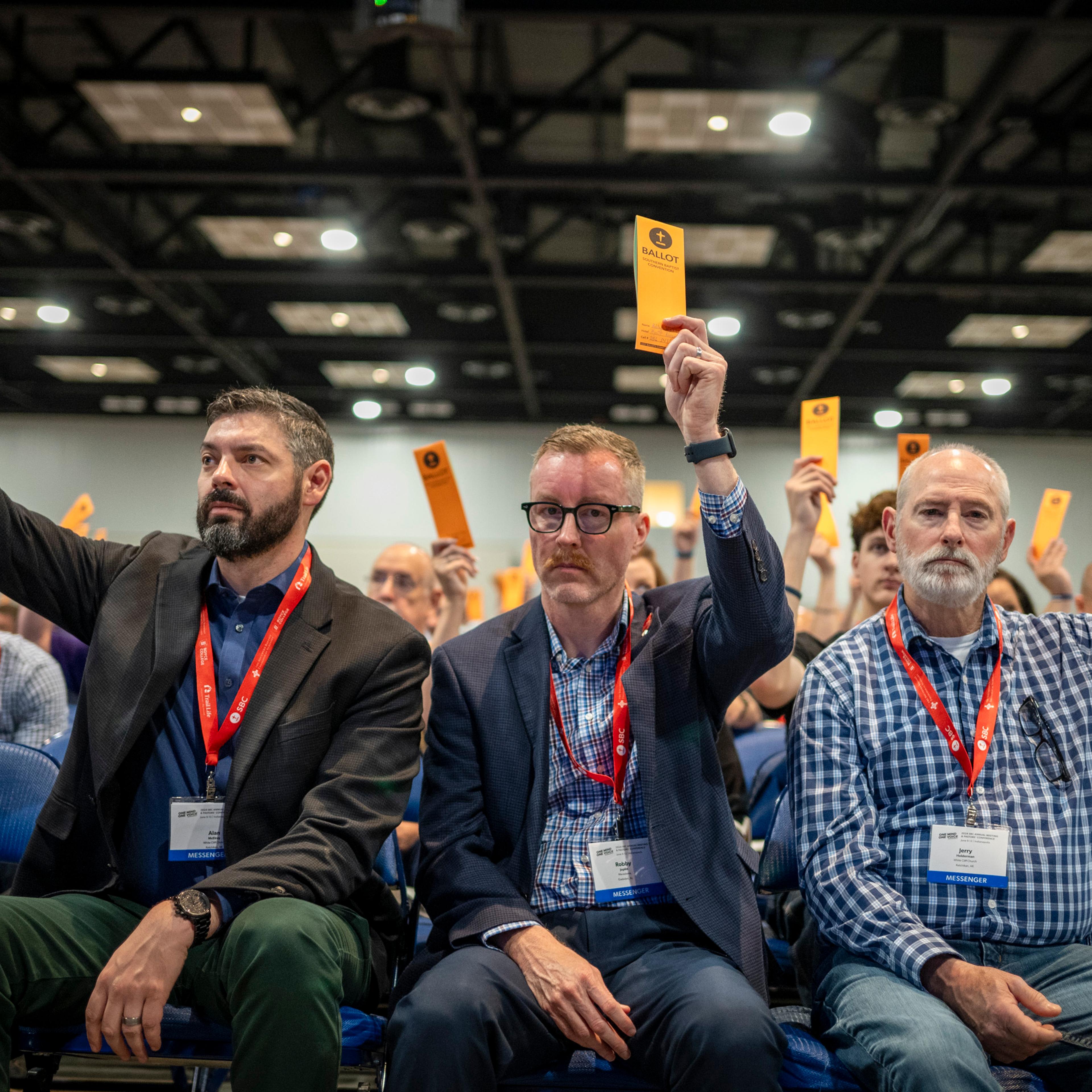 Messengers raise their ballots in support of a motion put up for vote during a Southern Baptist Convention annual meeting Tuesday, June 11, 2024, in Indianapolis