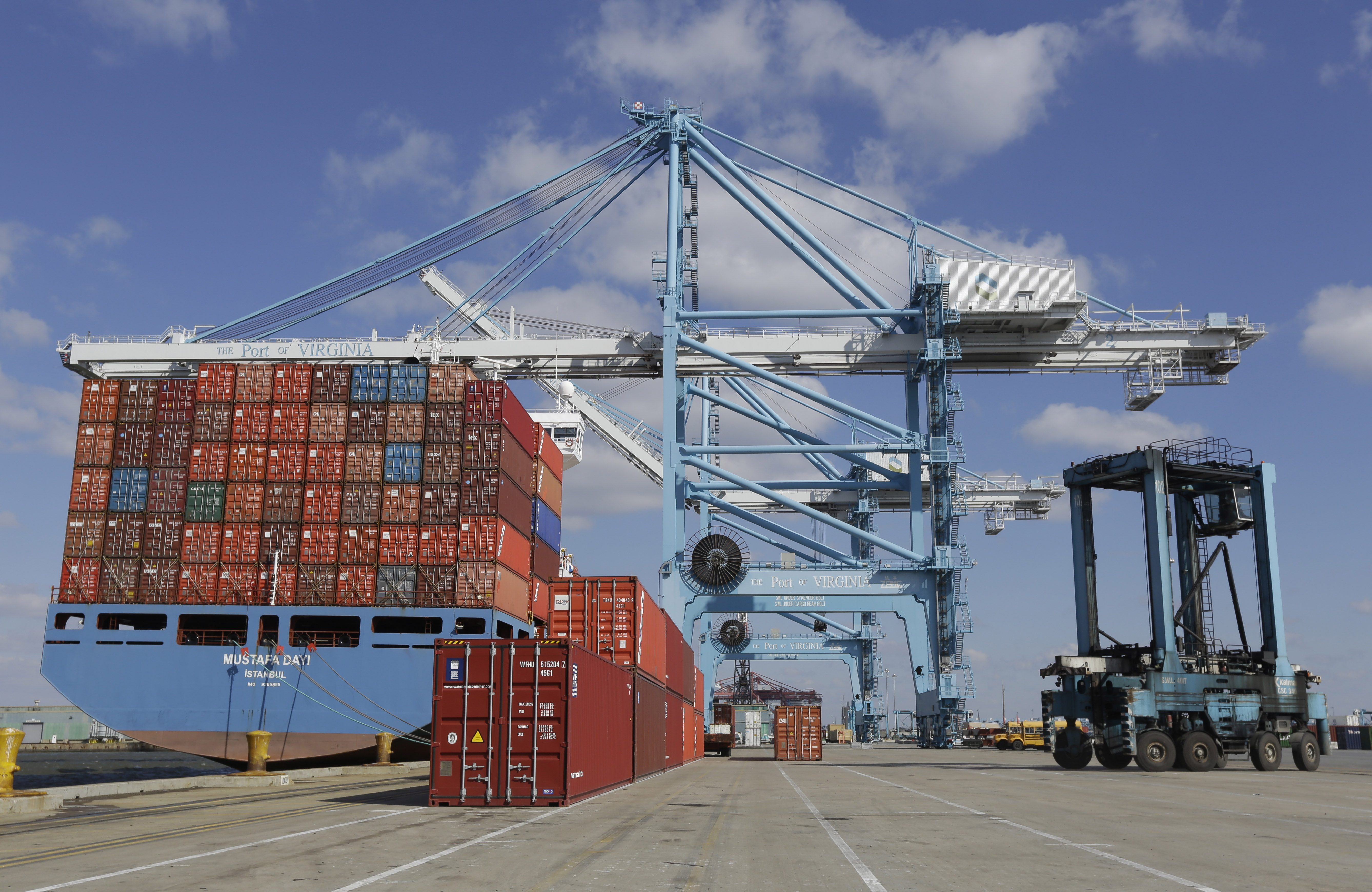 A rail mounted gantry crane, center, as well as a Straddle Carrier, right, used to unload and load a container ship at the Norfolk International Terminal in Norfolk, Va. on March 26, 2014.