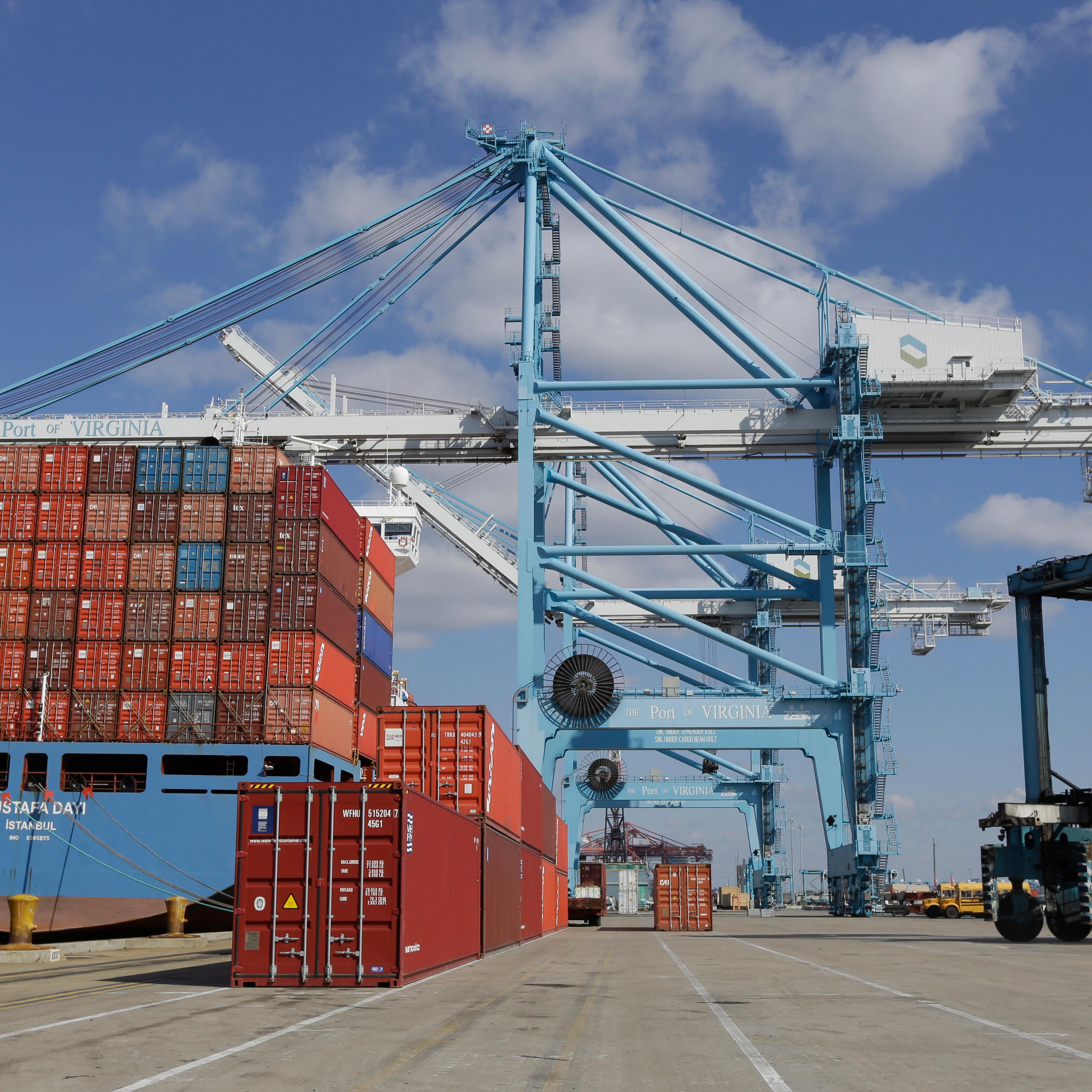 A rail mounted gantry crane, center, as well as a Straddle Carrier, right, used to unload and load a container ship at the Norfolk International Terminal in Norfolk, Va. on March 26, 2014.