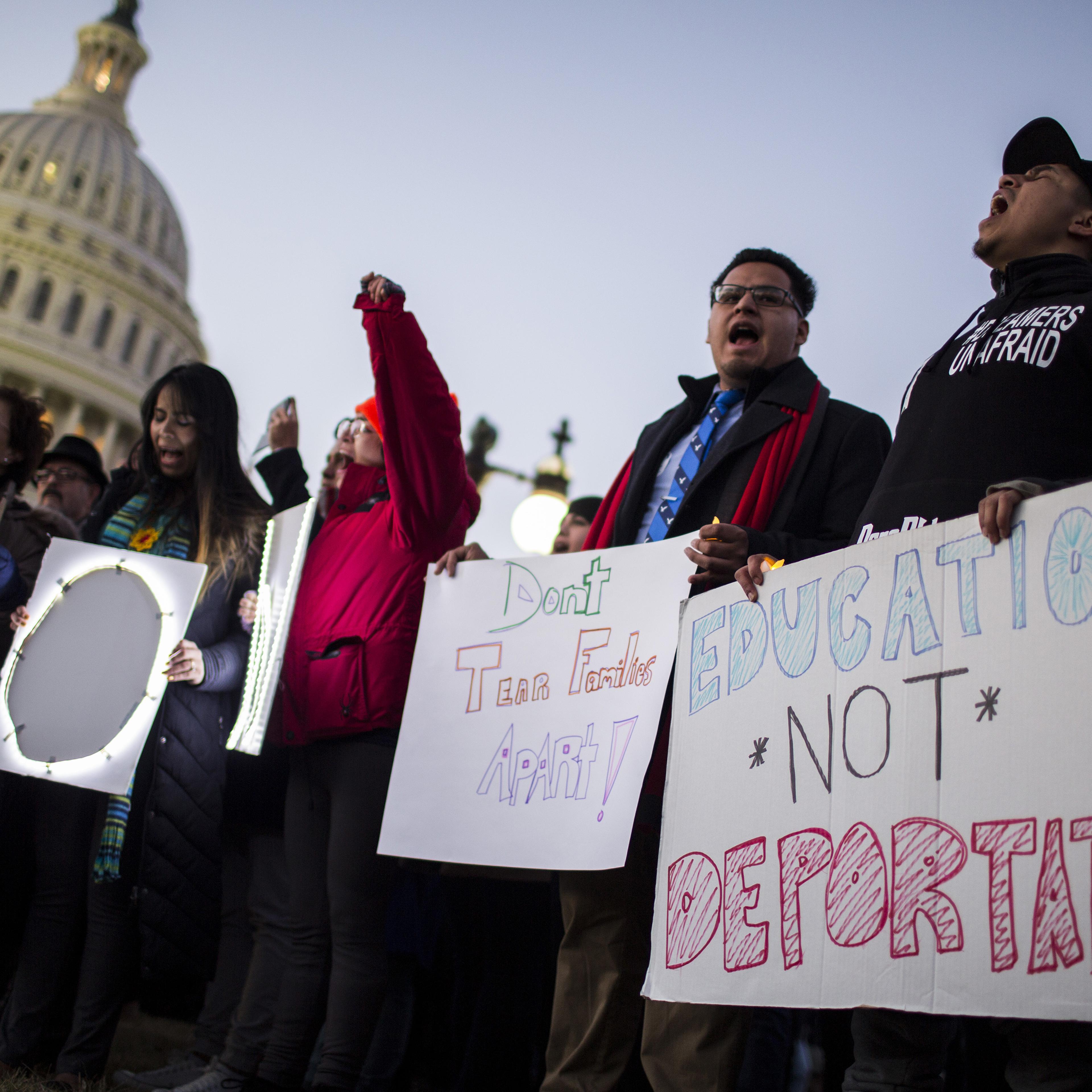 Demonstrators hold signs during a rally supporting the Deferred Action for Childhood Arrivals program (DACA), or the Dream Act, outside the U.S. Capitol building in Washington, D.C., U.S., on Thursday, Jan. 18, 2018.