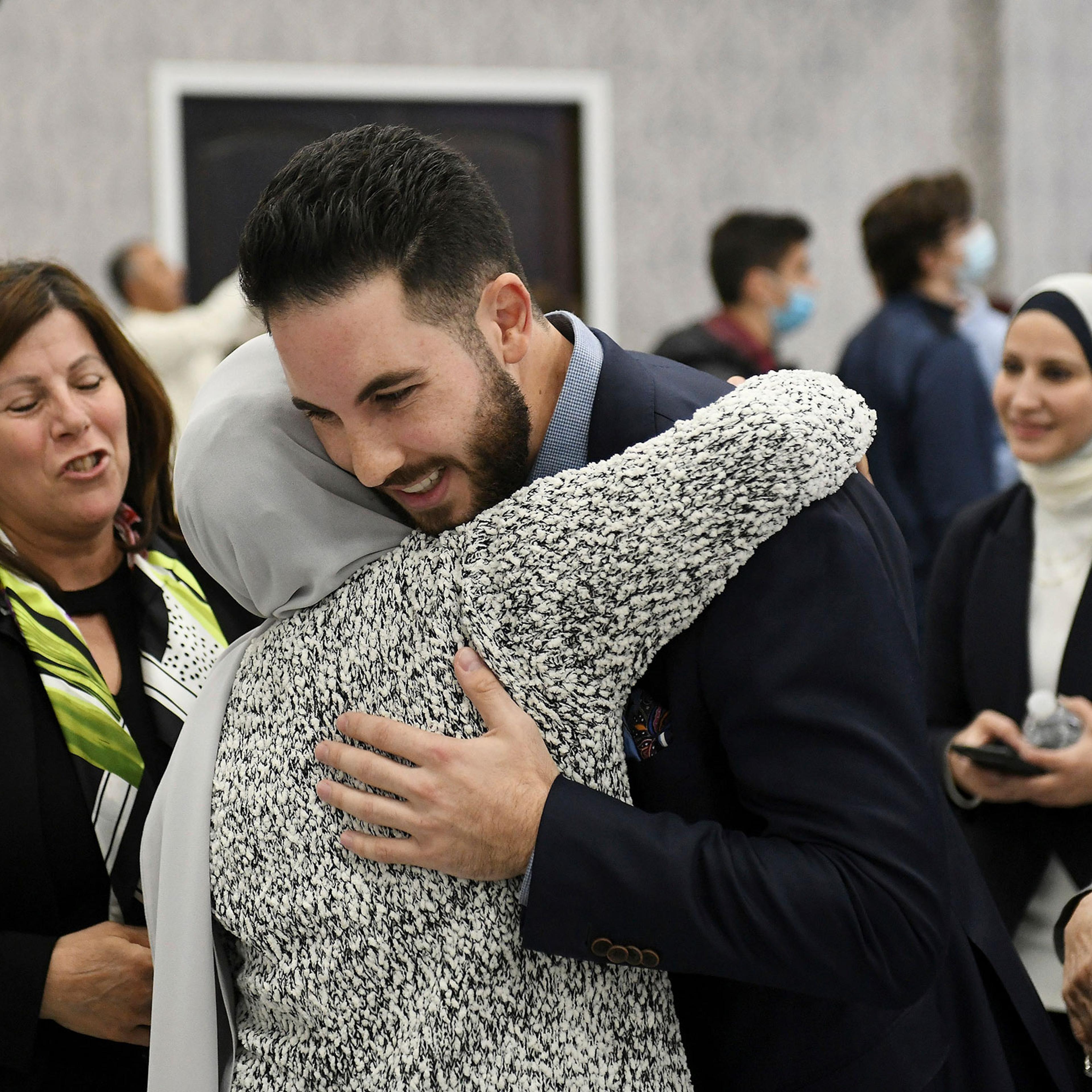 Dearborn mayor candidate Abdullah Hammoud hugs family members at the Mohammed Turfe Community Center in Dearborn, Mich.