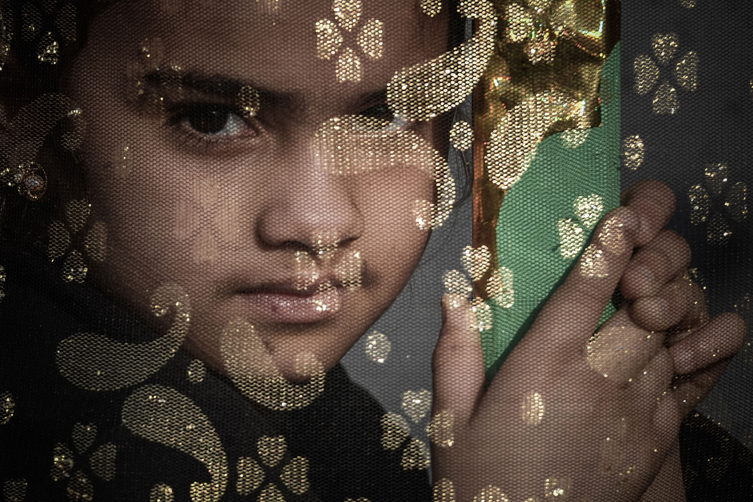 Jan. 3, 2013. A Bahraini Shiite Muslims girl watches the Arbaeen religious festival from a window in the village of Sanabis, west of Manama. 