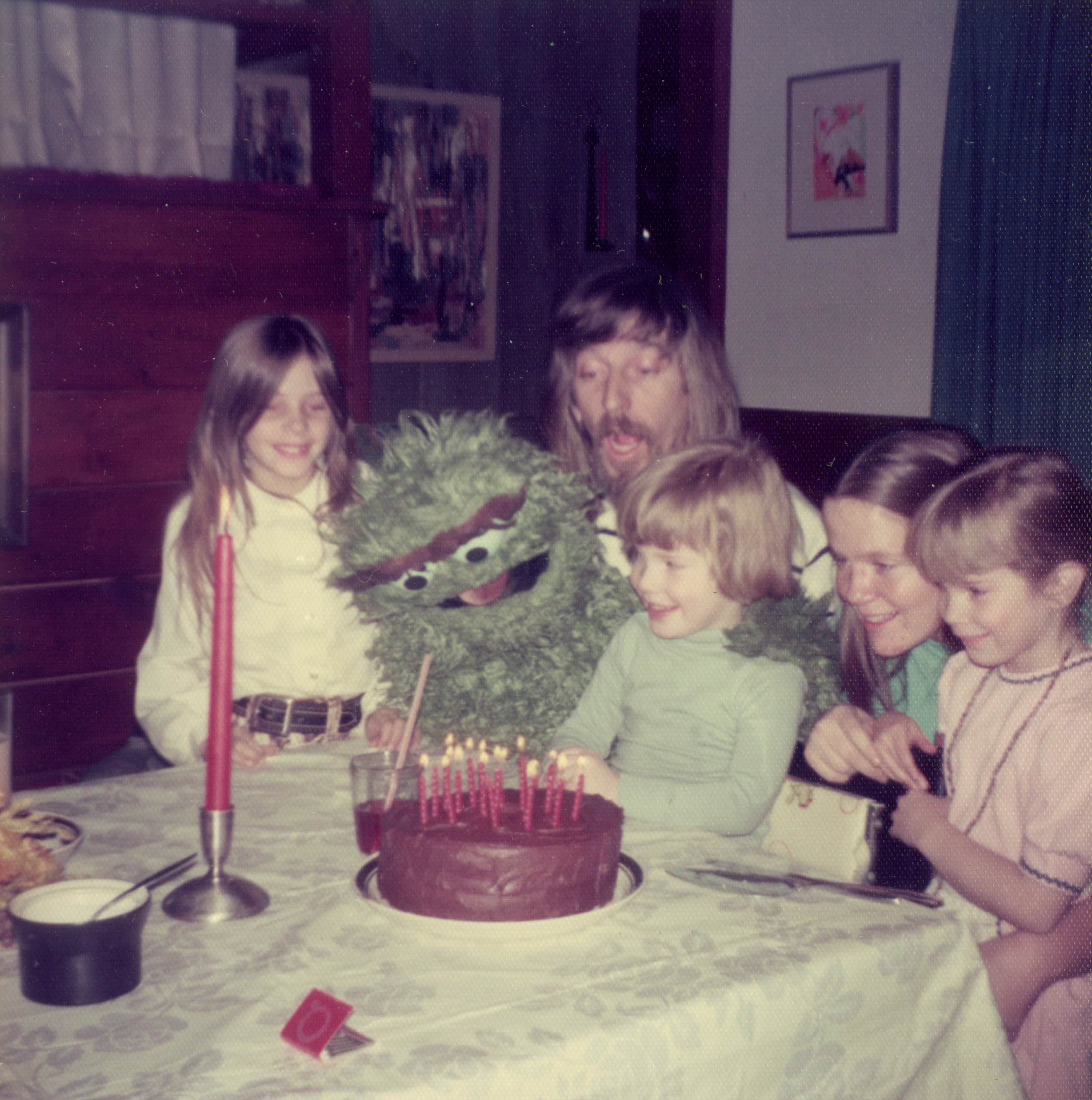 Caroll Spinney with his children and Oscar the Grouch at his child's birthday party.