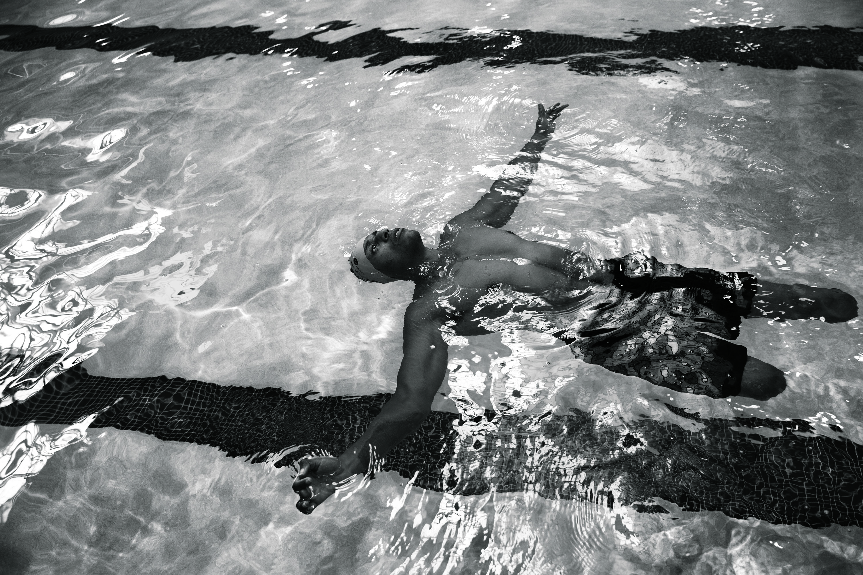 Wounded American service members in rehab at Walter Reed Hospital. Wayne Waldon, Army Capt., retired - leg amputee. Rock climb. Cedric King, Army Master Sergeant - bilateral leg amputee. Swimming pool. Stephanie Morris, Army E4 - external leg prosthetic.