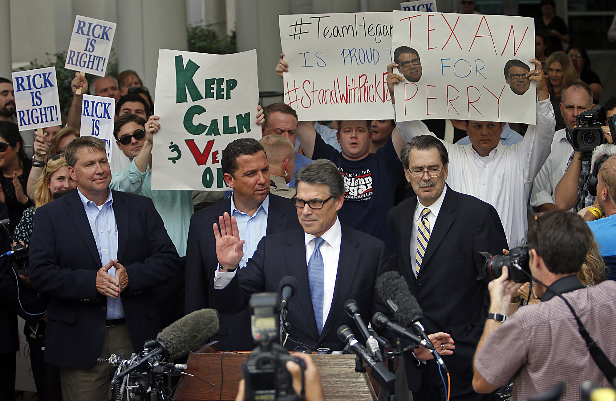 Texas Governor Rick Perry acknowledges the crowd after being finger printed at the Blackwell-Thurman Criminal Justice Center on Aug. 19, 2014 in Austin.